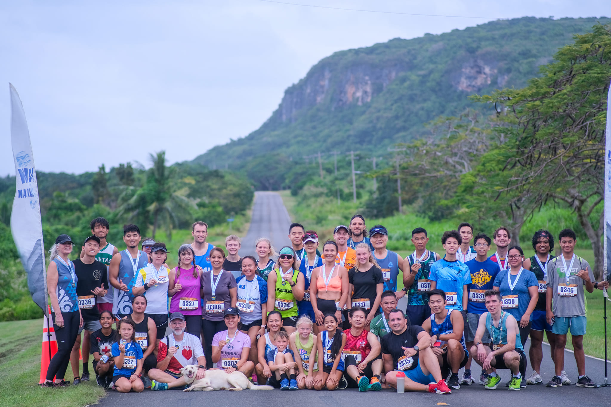 The participants of the 2nd Annual Run Saipan Trinity pose for a photo after completing day 3 of the event in the Route 30 "Drag Strip" area near the former Mariana Resort & Spa on Monday.