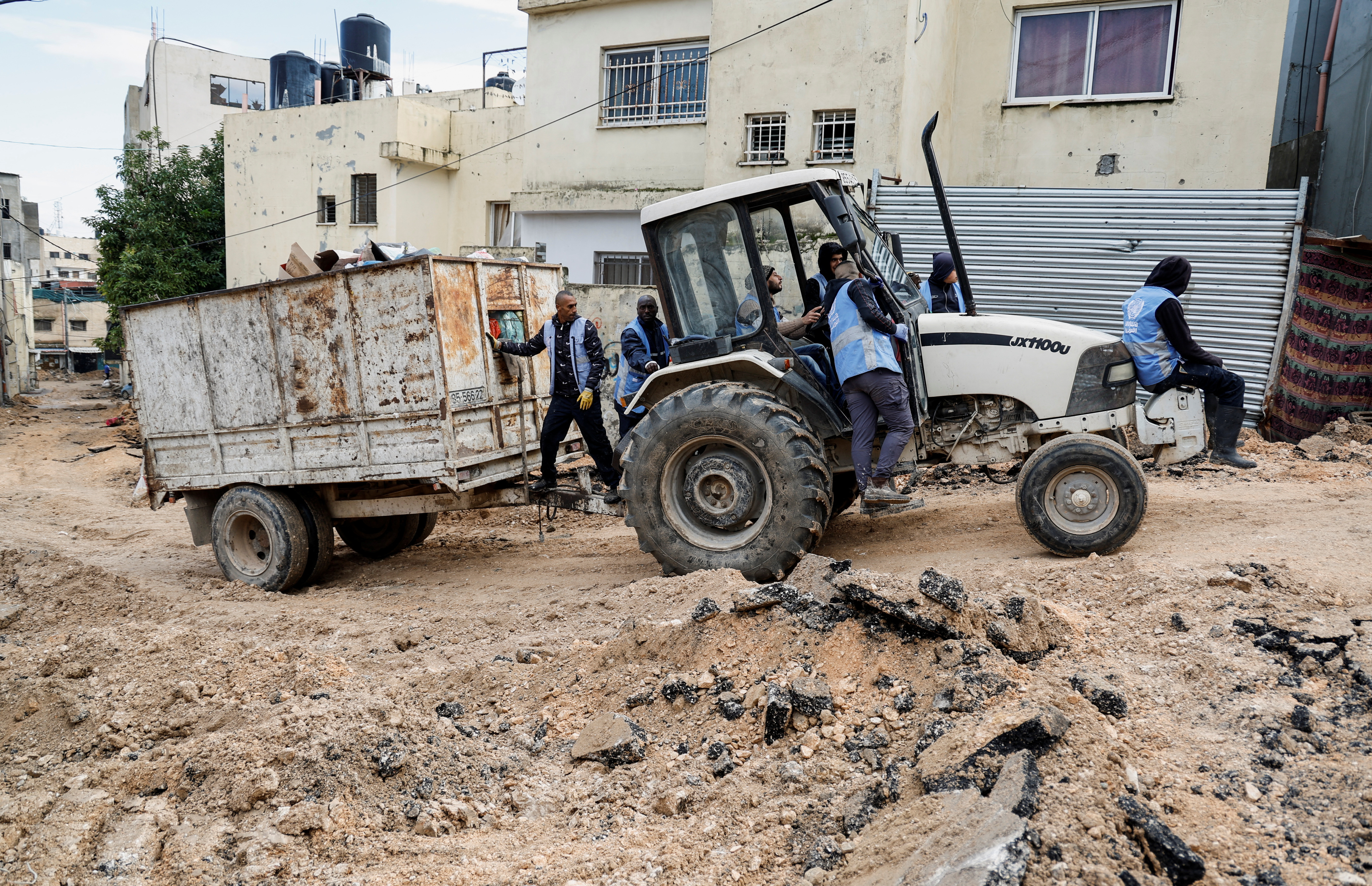 Members of UNRWA work, following an Israeli raid, in Jenin camp, in the Israeli-occupied West Bank January 29, 2024. 