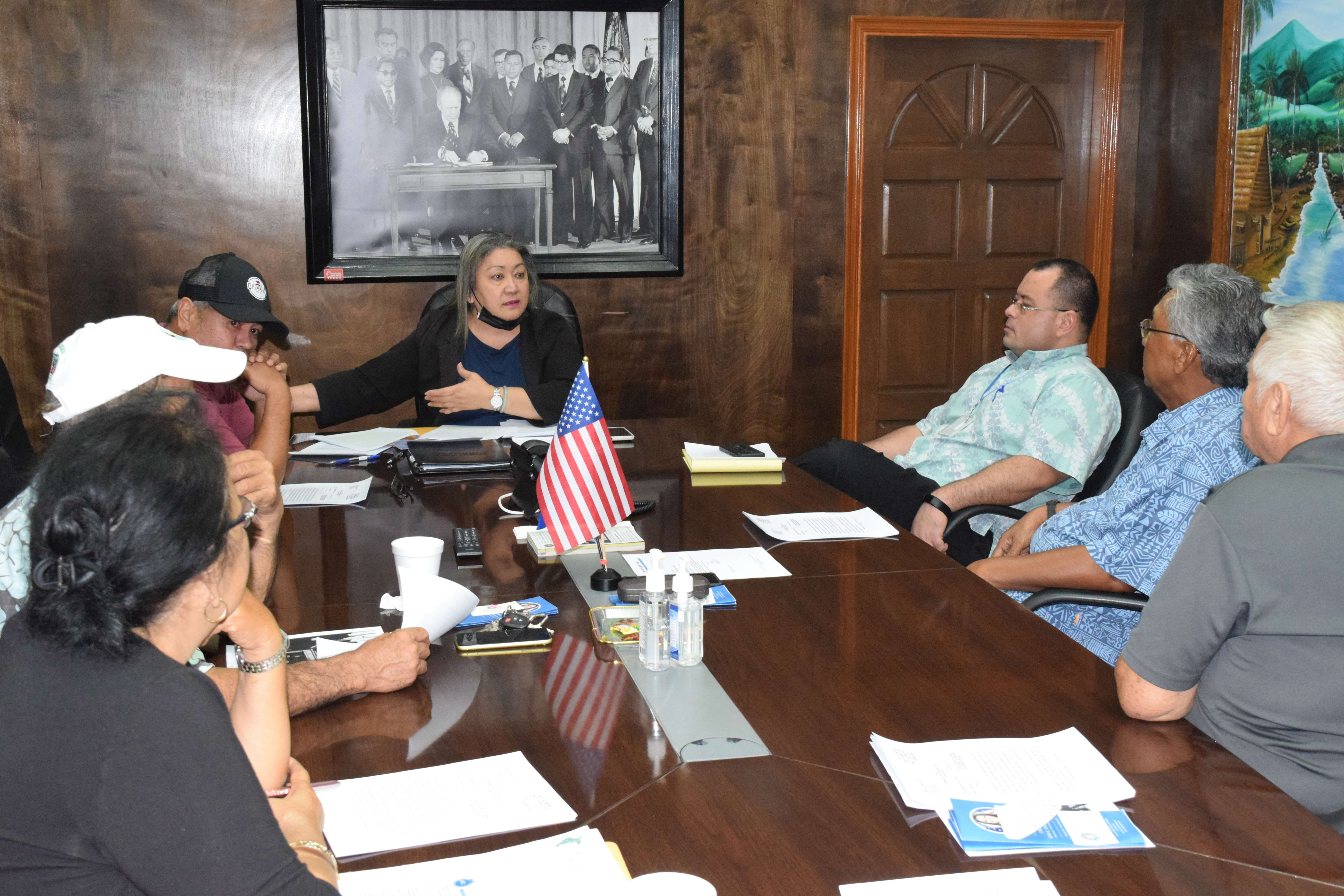 Senate President Edith Deleon Guerrero, center, gestures as she speaks to retirees while Speaker Edmund Villagomez, 3rd right, listens in the Senate president's conference room on Thursday.