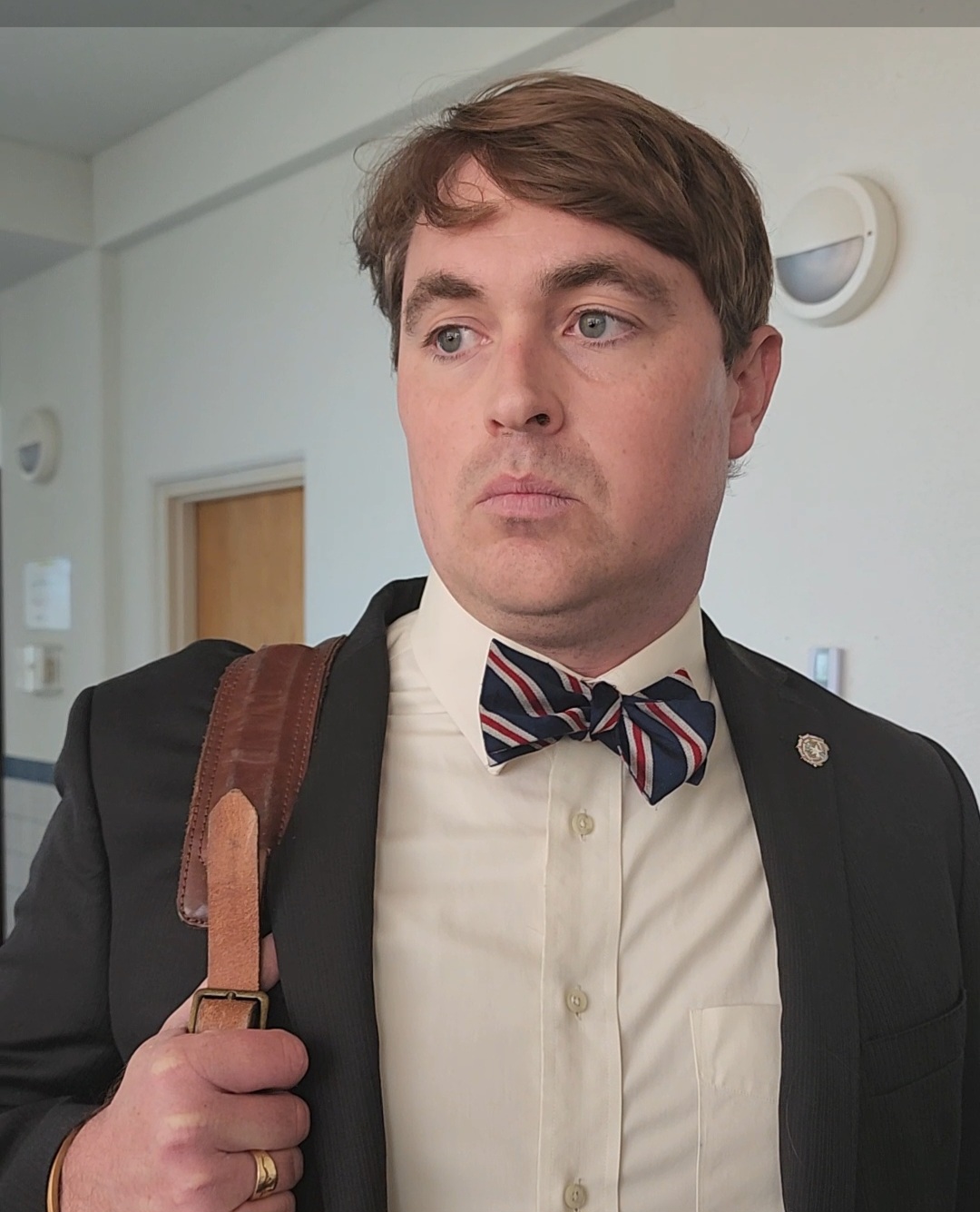 Assistant Attorney General James Robert Kingman listens to a question from a reporter at the local courthouse on Monday.