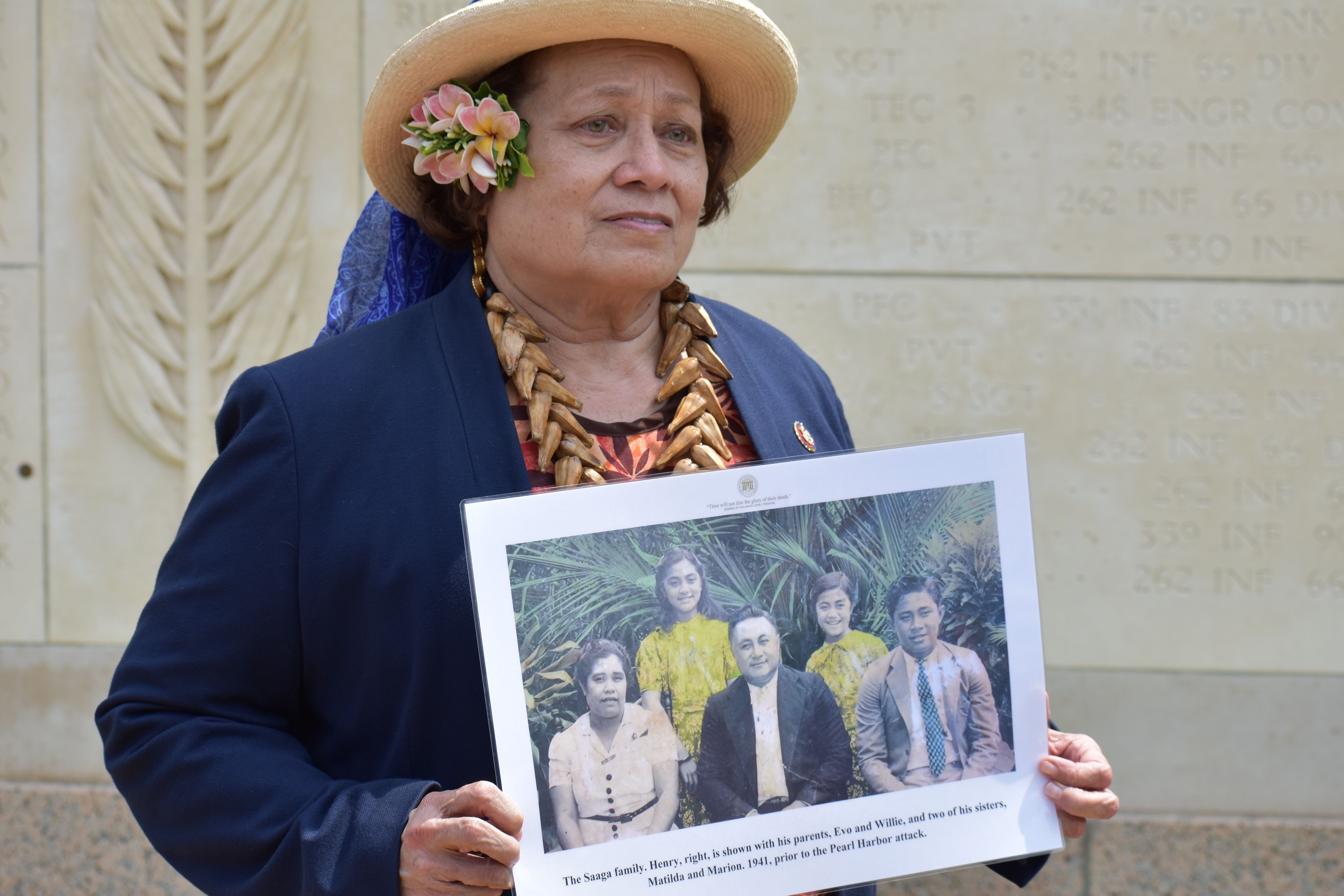 Congresswoman Amata holds a family photo of Pvt. Henry Saaga, who was killed in action in the Battle of Normandy, 1944. His body was never recovered.
