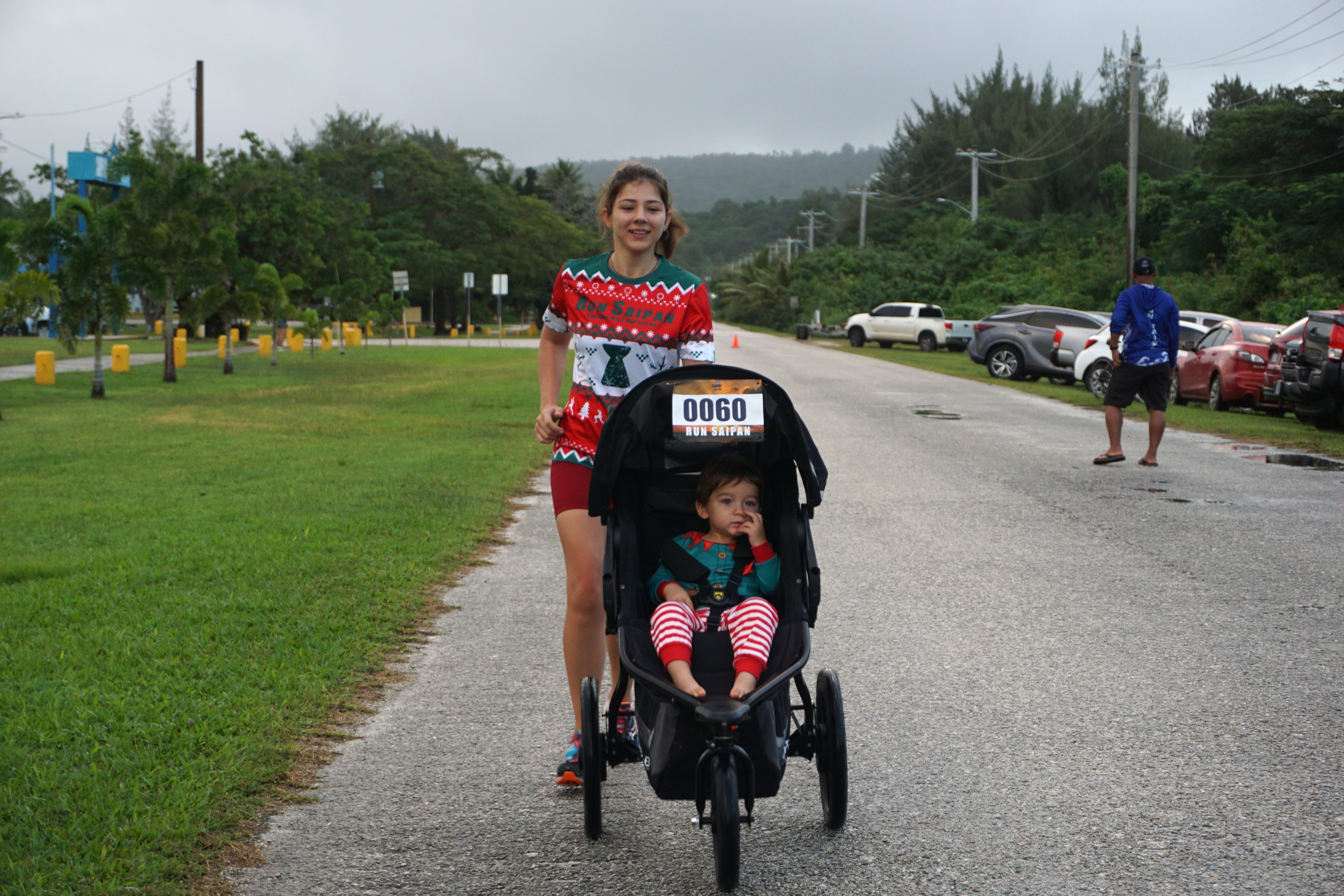 Anastasia Dela Cruz and son, Sasha, cross the finish line to top the stroller division of Run from 2023 at Smiling Cove Marina on Sunday.