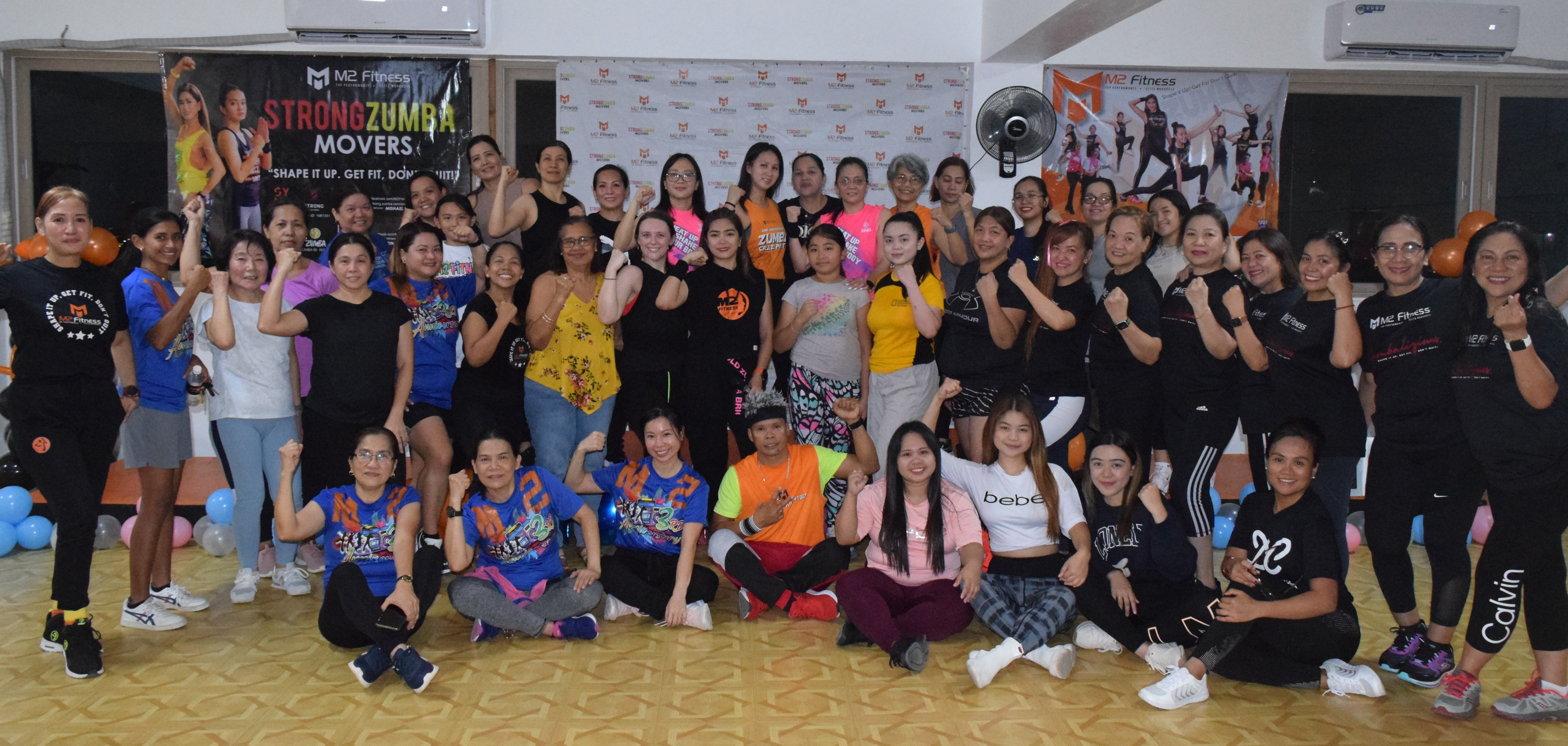 M2 Fitness President Mary Grace Bautista, center, poses for a photo with her M2 family after a sendoff session at the M2 Fitness Studio on Middle Road, Gualo Rai on Saturday.