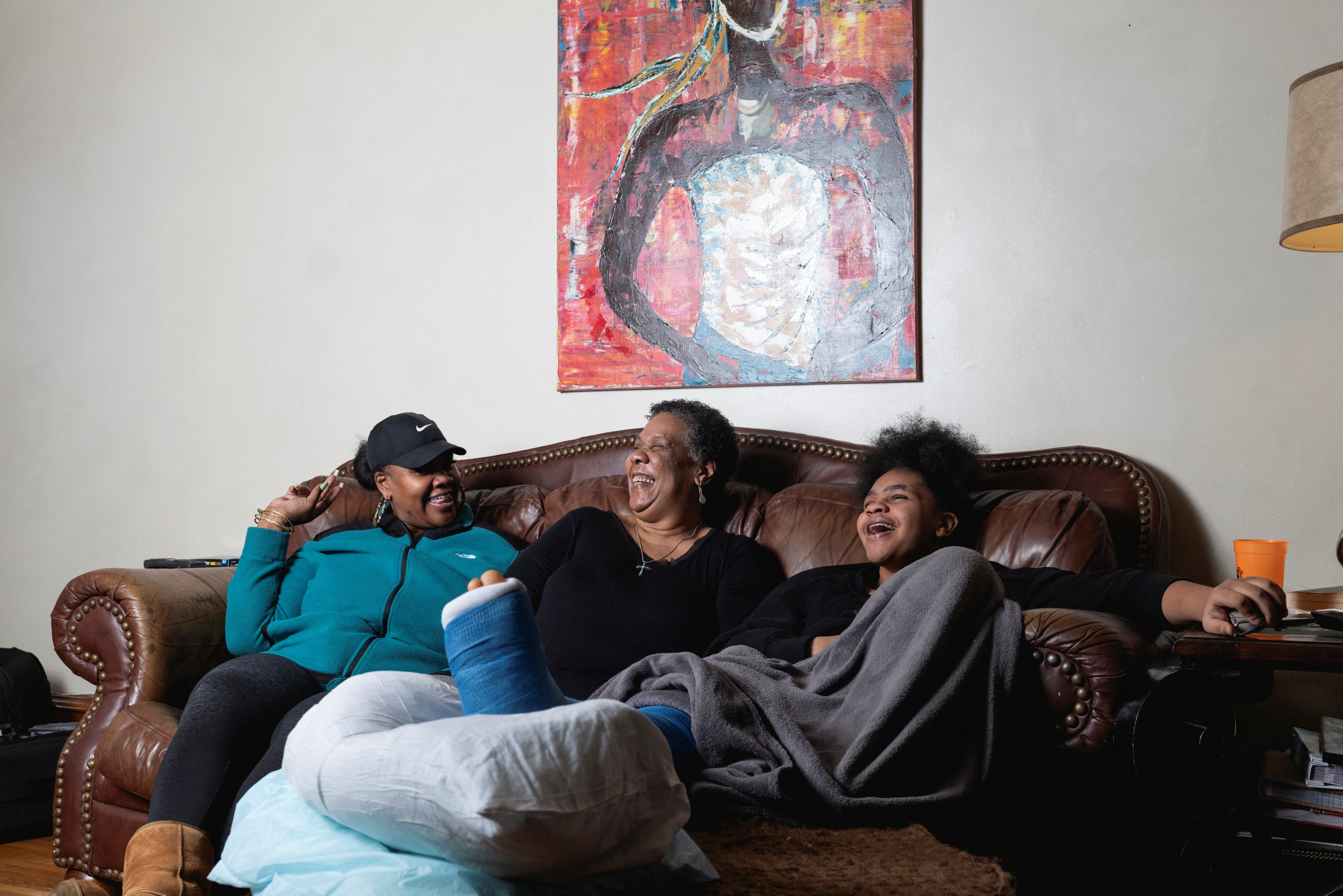 Charla Plaines, a 66-year-old grandmother, talks to her 42-year-old daughter, Ione Brannon, and Ione's daughter, 11-year-old Loyalty Johnson, in the living room of their home in Harrisburg, Pennsylvania, U.S., December 28, 2023. 