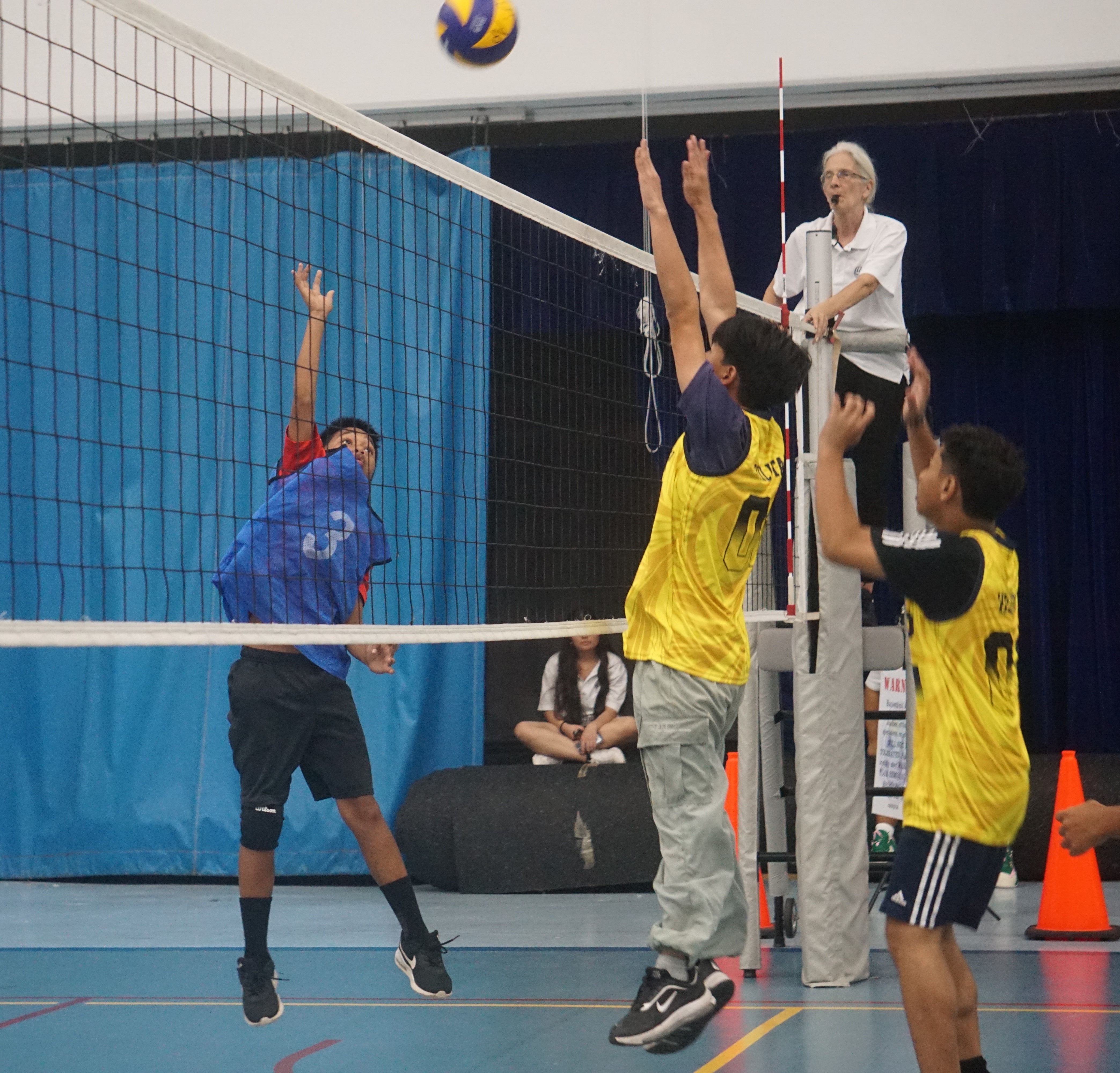 A Tanapag Middle School II player attempts the spike against two Hopwood Middle School II defenders during a boys middle school division game of the NMIVA-PSS Interscholastic Volleyball League SY23-24 at the Marianas High School gym on Thursday.
