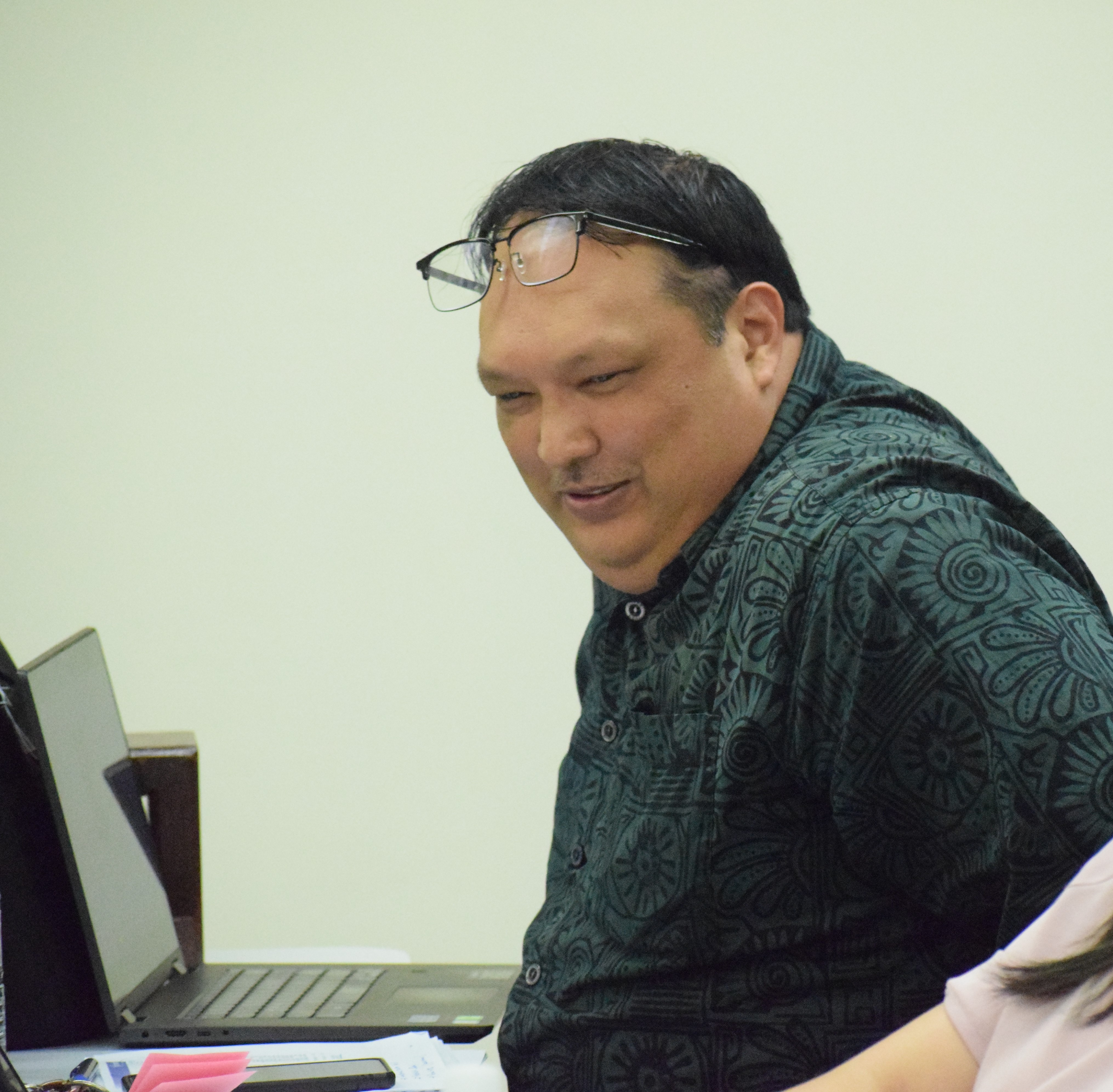 Office of Grants Management & State Clearinghouse Administrator Epiphanio E. Cabrera Jr. smiles during a meeting with senators in Nov. 2023.