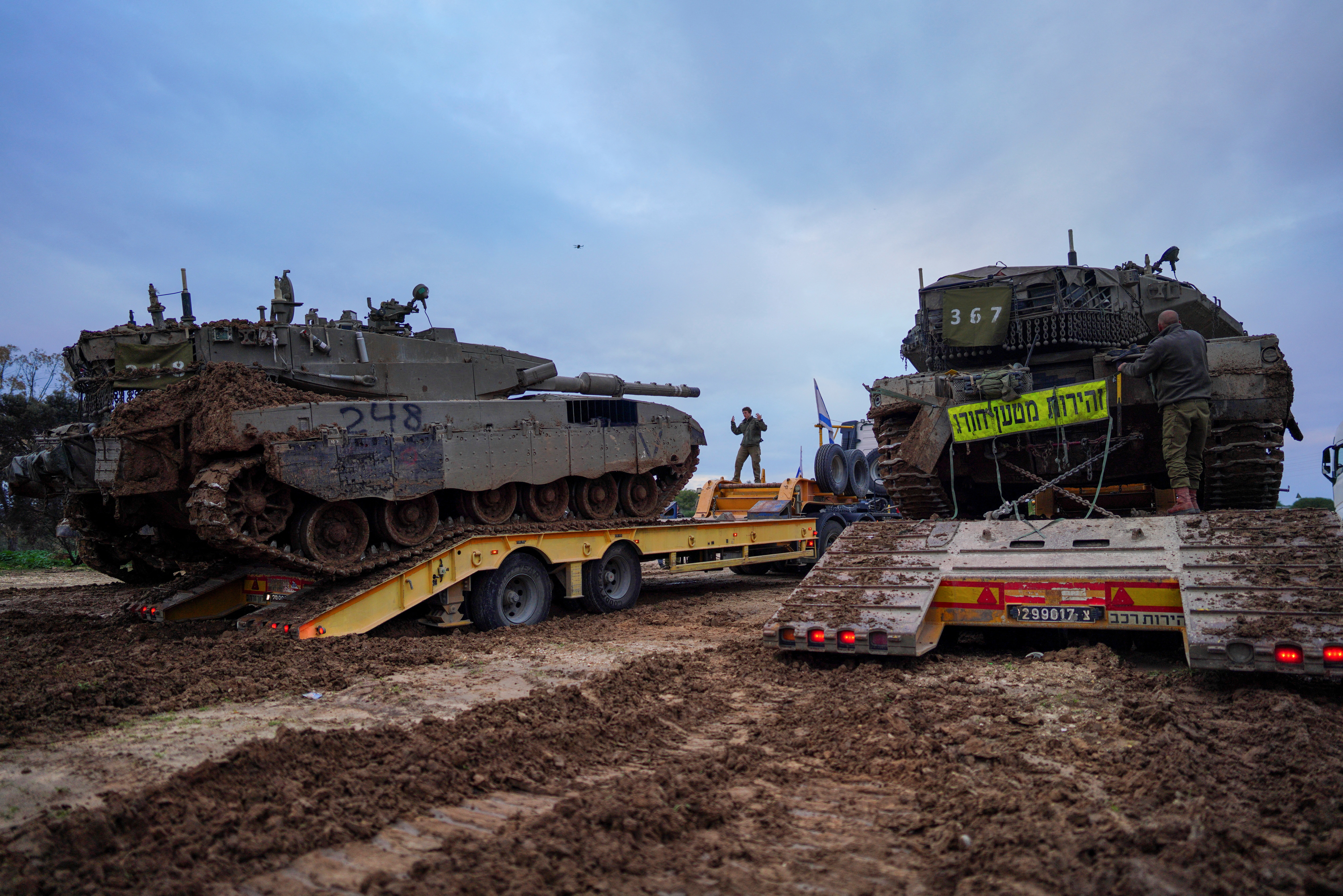 Tanks are loaded on trucks, amid the ongoing conflict between Israel and Palestinian Islamist group Hamas, at the Israeli border with Gaza, January 28, 2024. 
