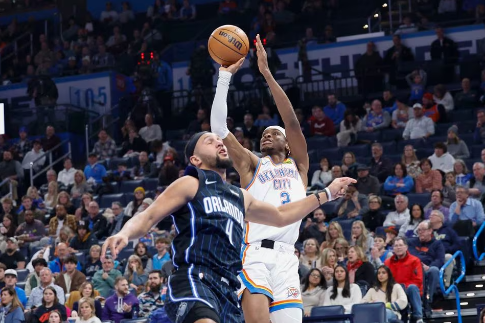 Oklahoma City Thunder guard Shai Gilgeous-Alexander (2) shoots over Orlando Magic guard Jalen Suggs (4) during the second half at Paycom Center in Oklahoma City, Oklahoma, Jan. 13, 2024.