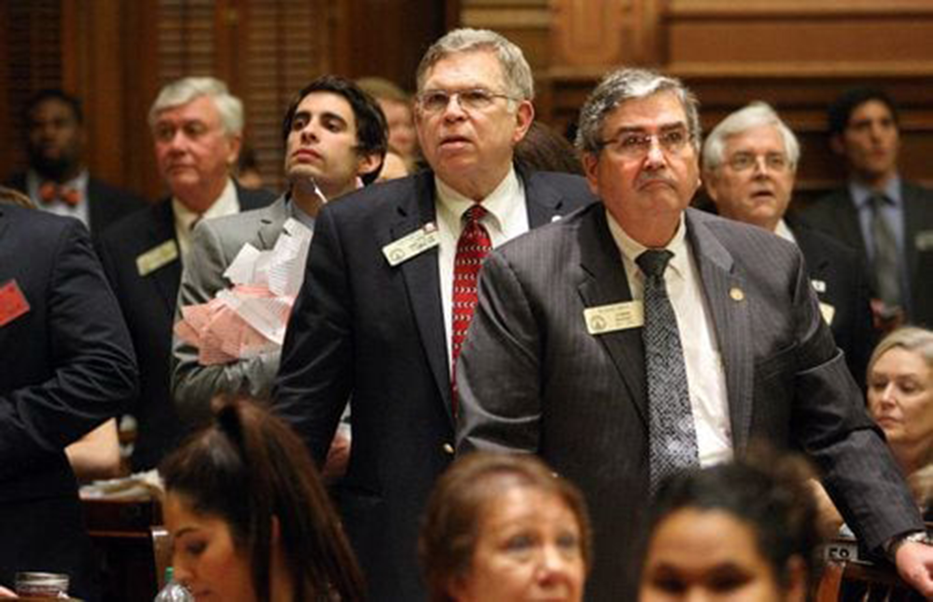 Minutes before midnight, Rep. Don Parsons, R-Marietta, center, and Rep. Richard Smith, R-Columbus, center right, anxiously await the end of the legislative session at the Capitol Thursday night in Atlanta, Ga., March 29, 2012. (Jason Getz/The Atlanta Journal-Constitution/TNS)