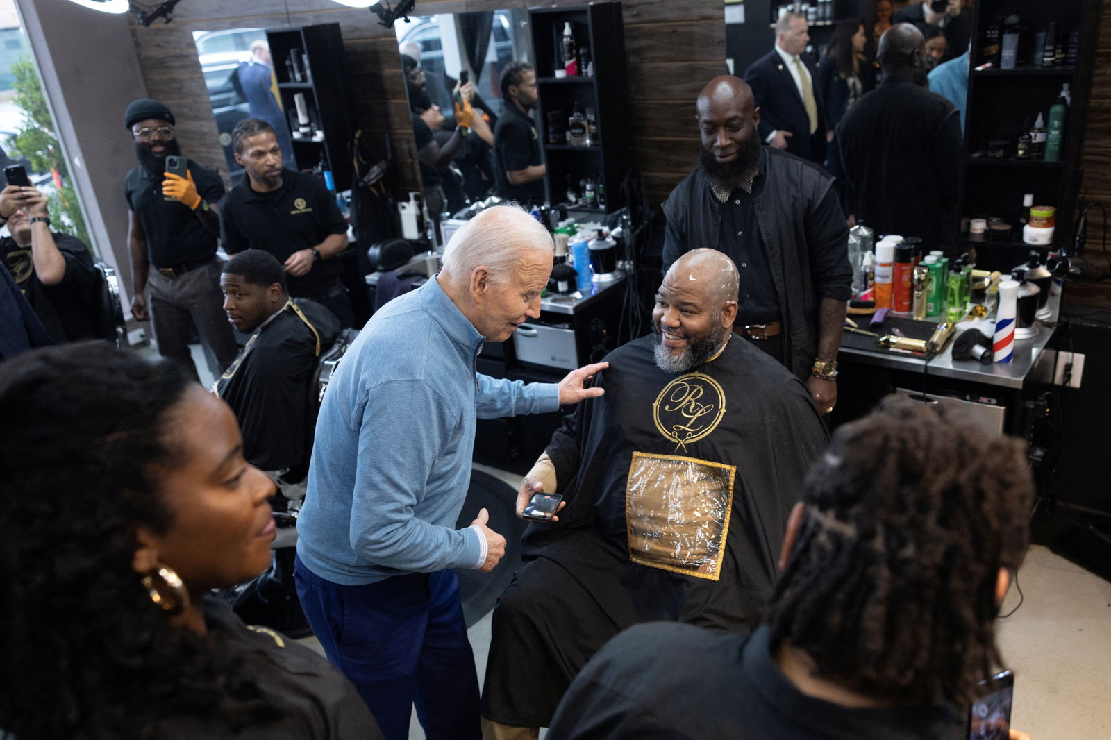 U.S. President Joe Biden greets a patron during an unannounced visit to Regal Lounge barber shop in Columbia, South Carolina, U.S., January 27, 2024. 