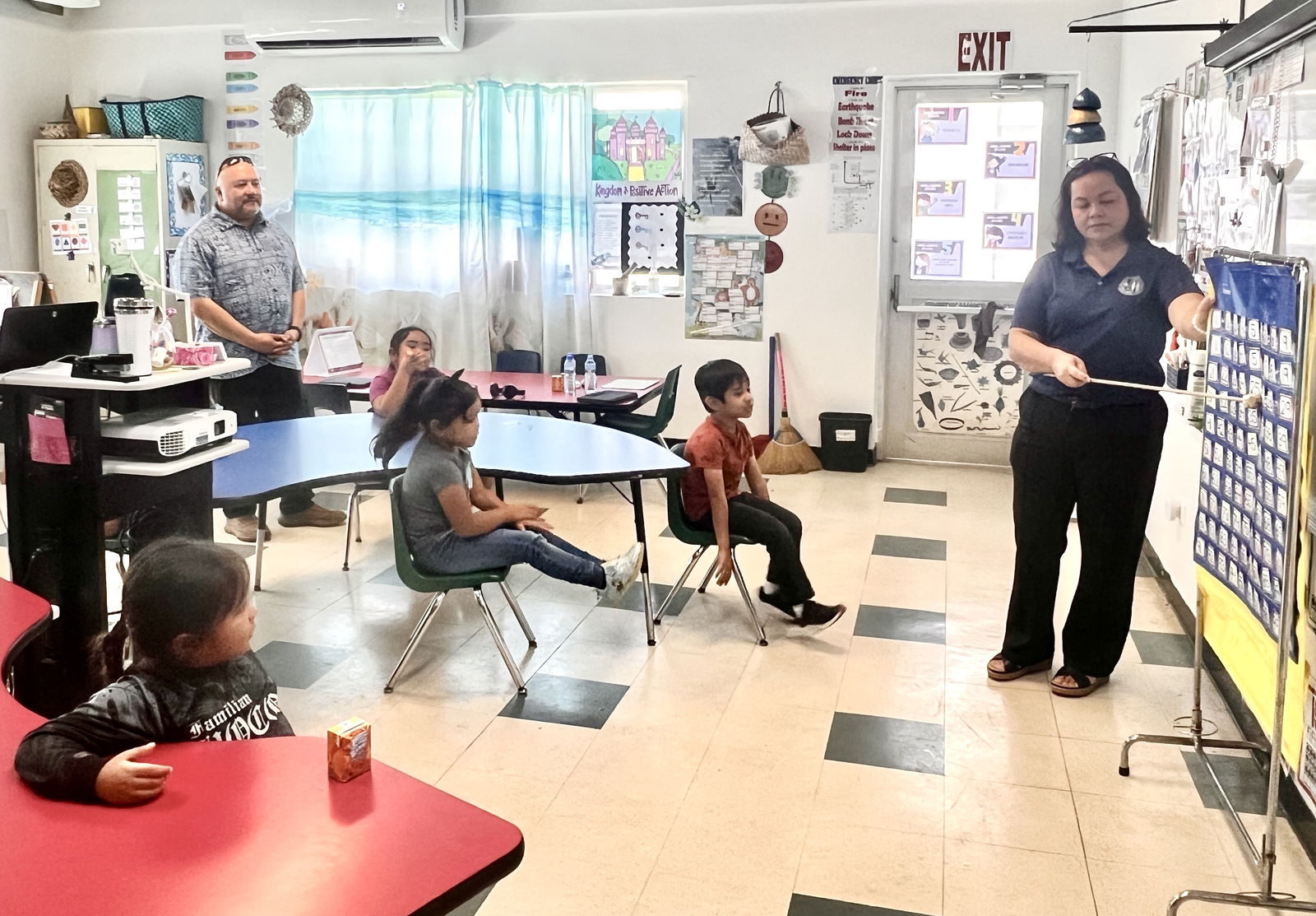 The students of the Chamorro and Carolinian Language and Heritage Studies Immersion Program class of Tricia Manglona count numbers in Chamorro while Commissioner of Education Dr. Lawrence F. Camacho looks on.