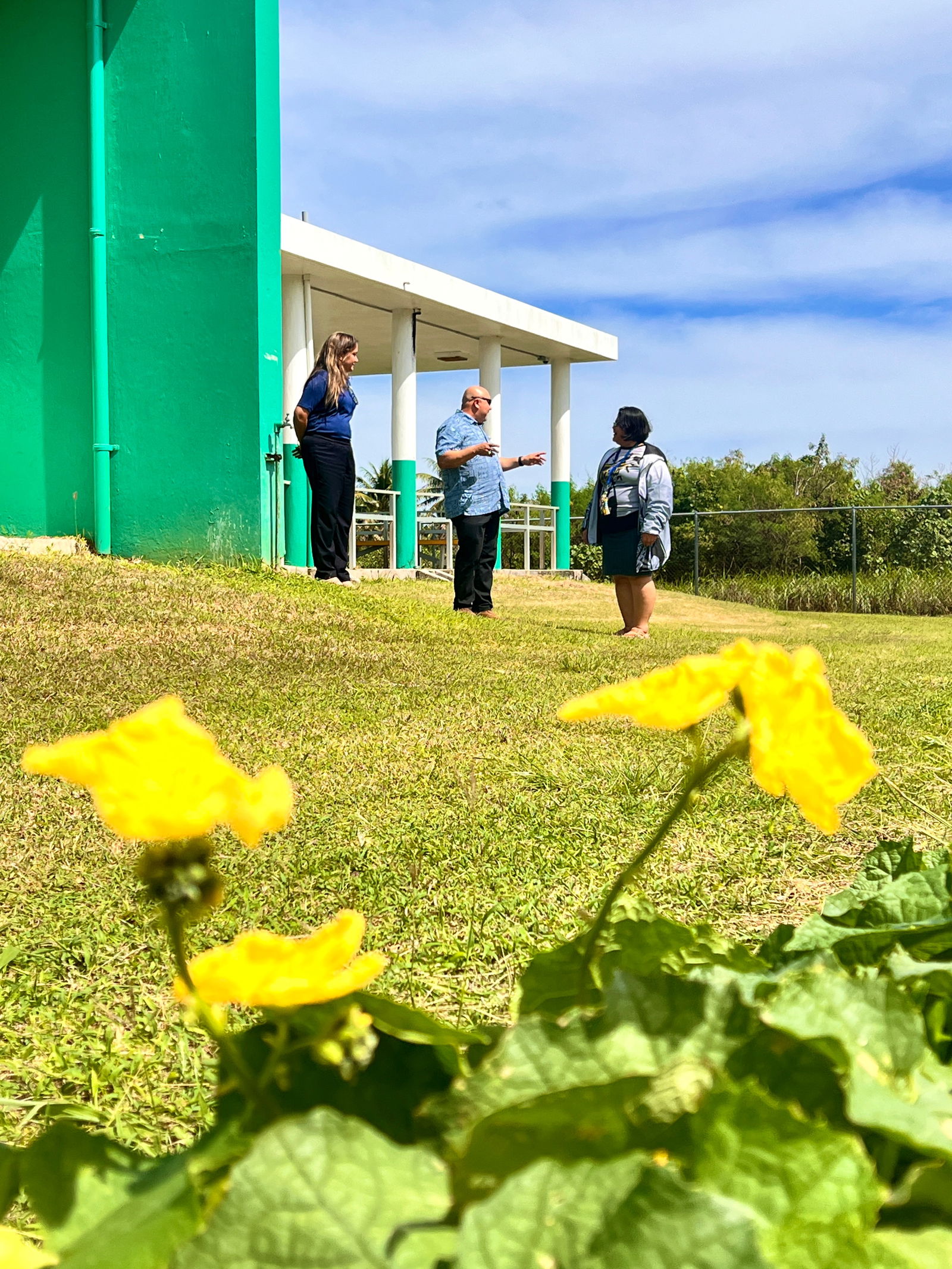 Commissioner of Education Dr. Lawrence Camacho, center, discusses Sinapalo Elementary School’s agriculture/farming school program with Principal Daisy Quitugua, right. Also in photo is Special Education Program Director Donna M. Flores.