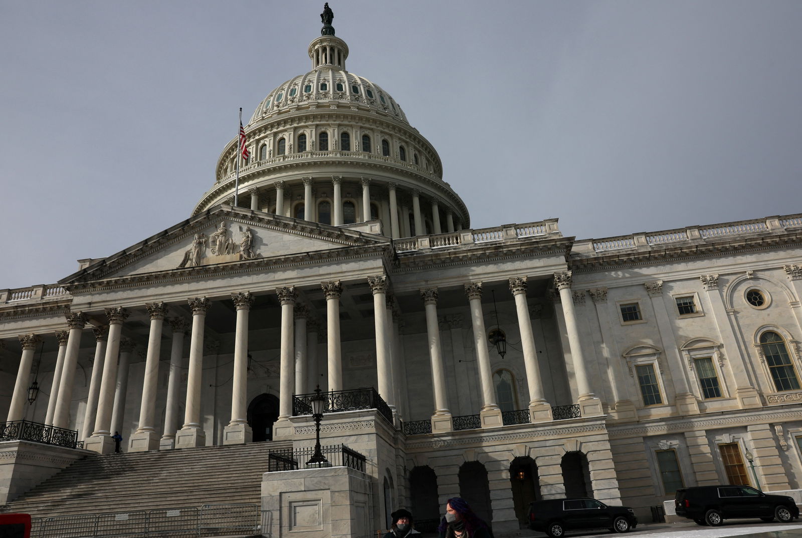 People walk past the U.S. Capitol building as the deadline to avoid partial government shutdown looms in Washington, U.S., January 18, 2024. 
