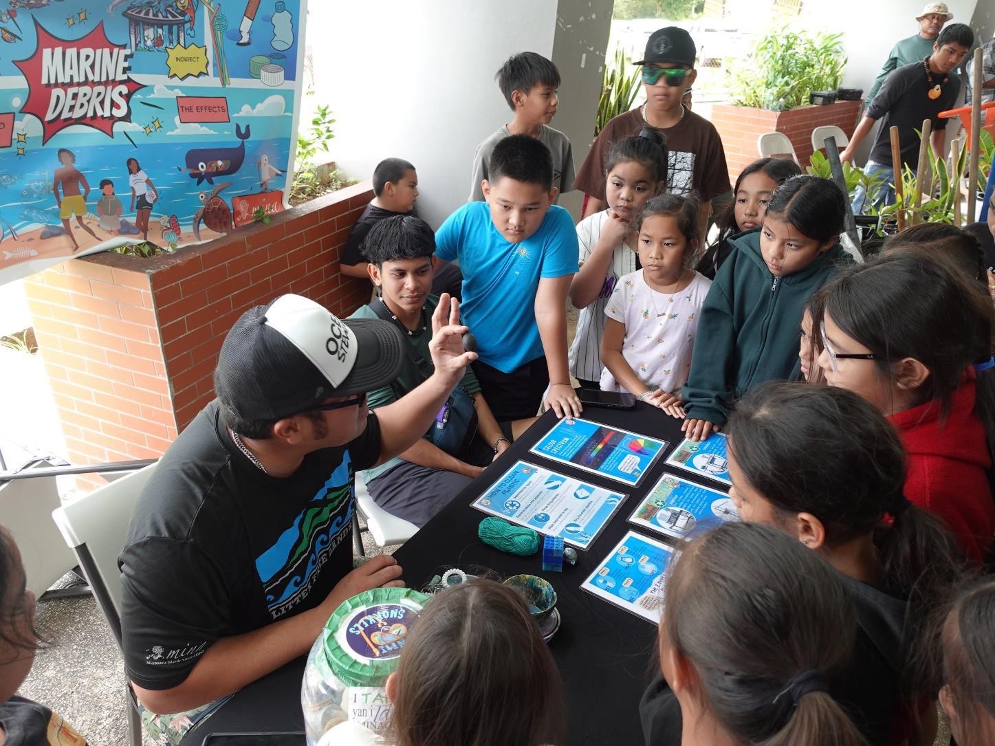 MY WAVE Club members learn from the Mariana Islands Nature Alliance about the dangers of marine debris at Garapan Central Park  during the Marianas Tourism Education Council Tourism Summit on Jan. 19, 2024.