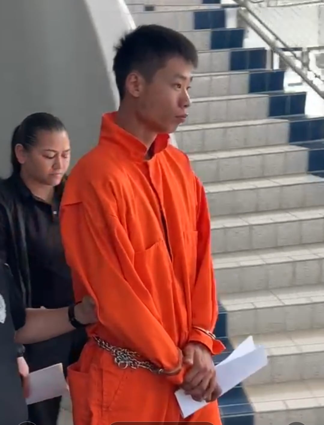 Joseph Lee is escorted by a Corrections officer after a bail hearing on Tuesday afternoon.
