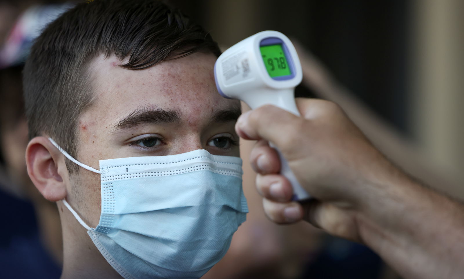 David Rooney, a student at Michigan?s Clarkston Junior High School, gets a temperature check before boarding a tour bus during his 8th grade trip to Washington, in Sterling, VA, U.S., U.S., June 18, 2021. 