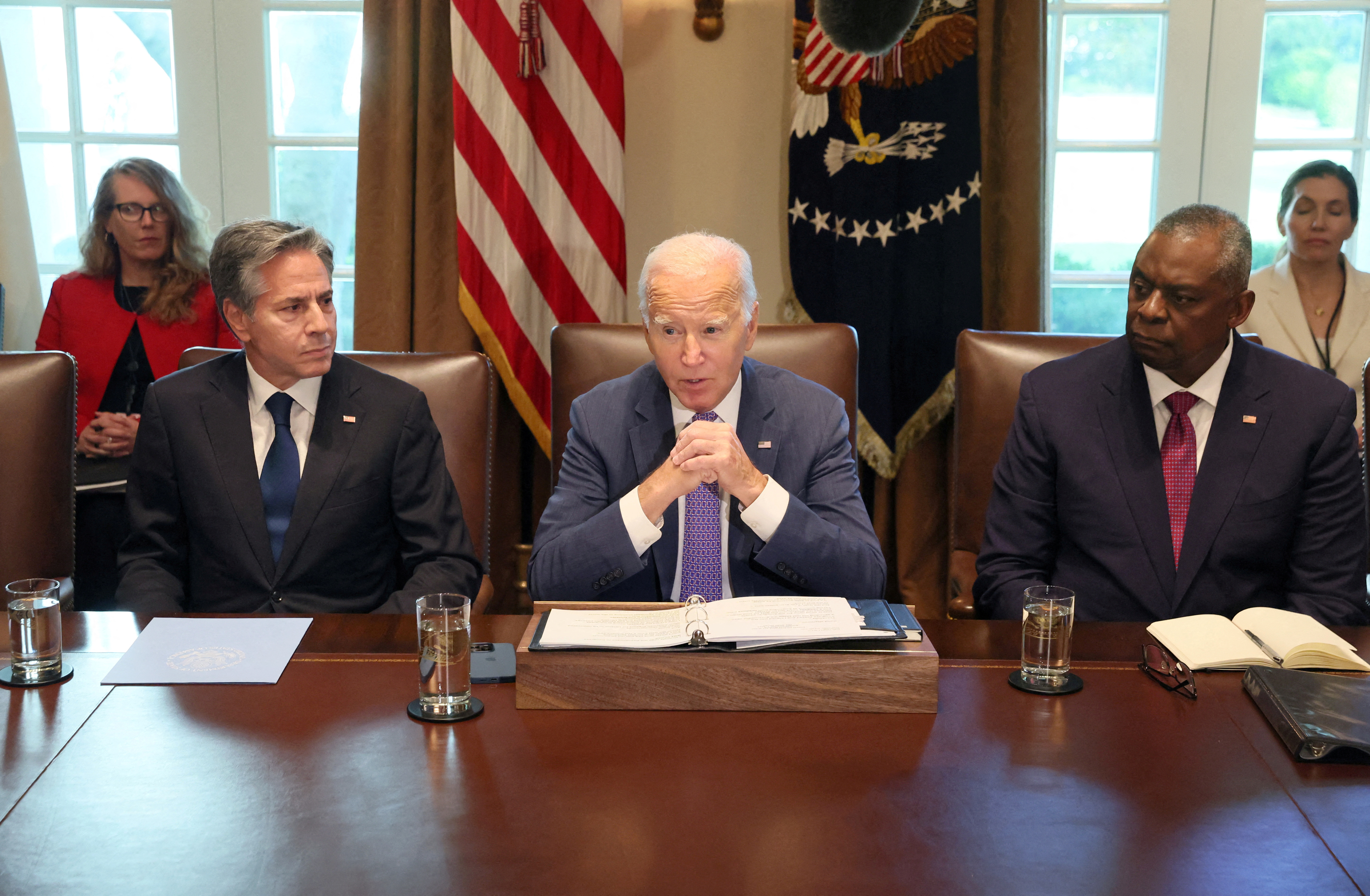 U.S. President Joe Biden, flanked by Secretary of State Antony Blinken and Secretary of Defense Lloyd Austin, makes a statement to the news media ahead of a cabinet meeting at the White House in Washington, U.S., October 2, 2023. 