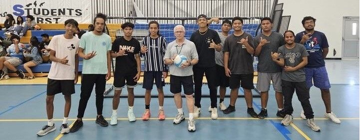 Team Topshakaz and Team Chagi Fahn players pose with James Feger, founder of the sport Rocball, in the Marianas High School gym's indoor court.