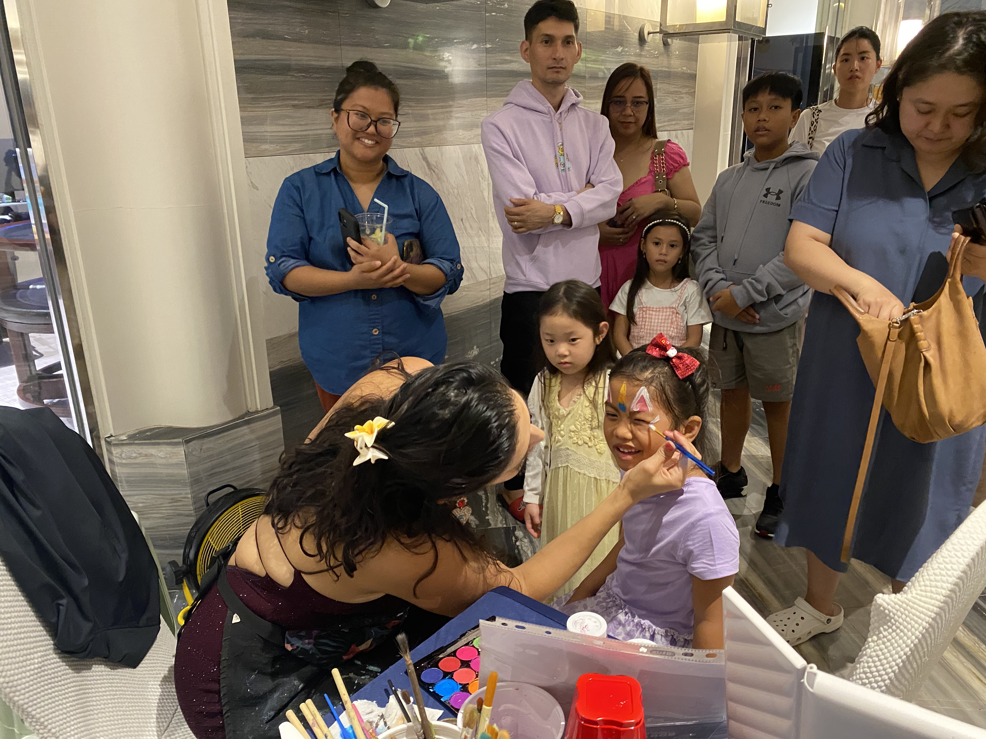 Aubrey Roberto visits Xochitl, run by Veronica Ariola, to get unicorn face paint.