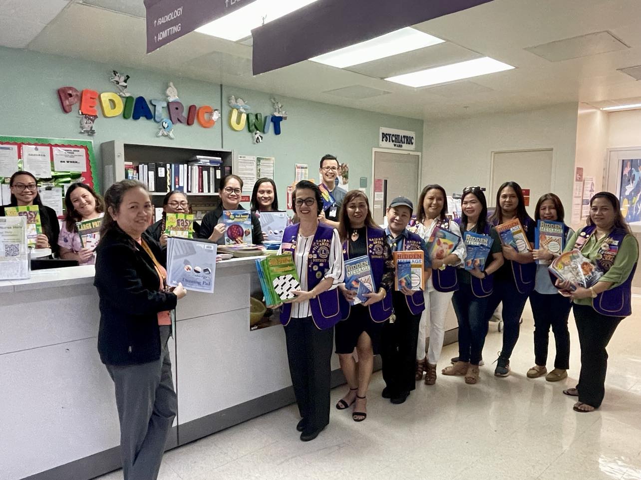 Front row: CHCC Director of Nursing Grace Laxina, Saipan Fil-American Lions Club President Socorro Huliganga, and members. Behind the counter:  Pediatric Manager Jeanneth Muyalde, Dr. Michael Pham, social workers and pediatric nurses.