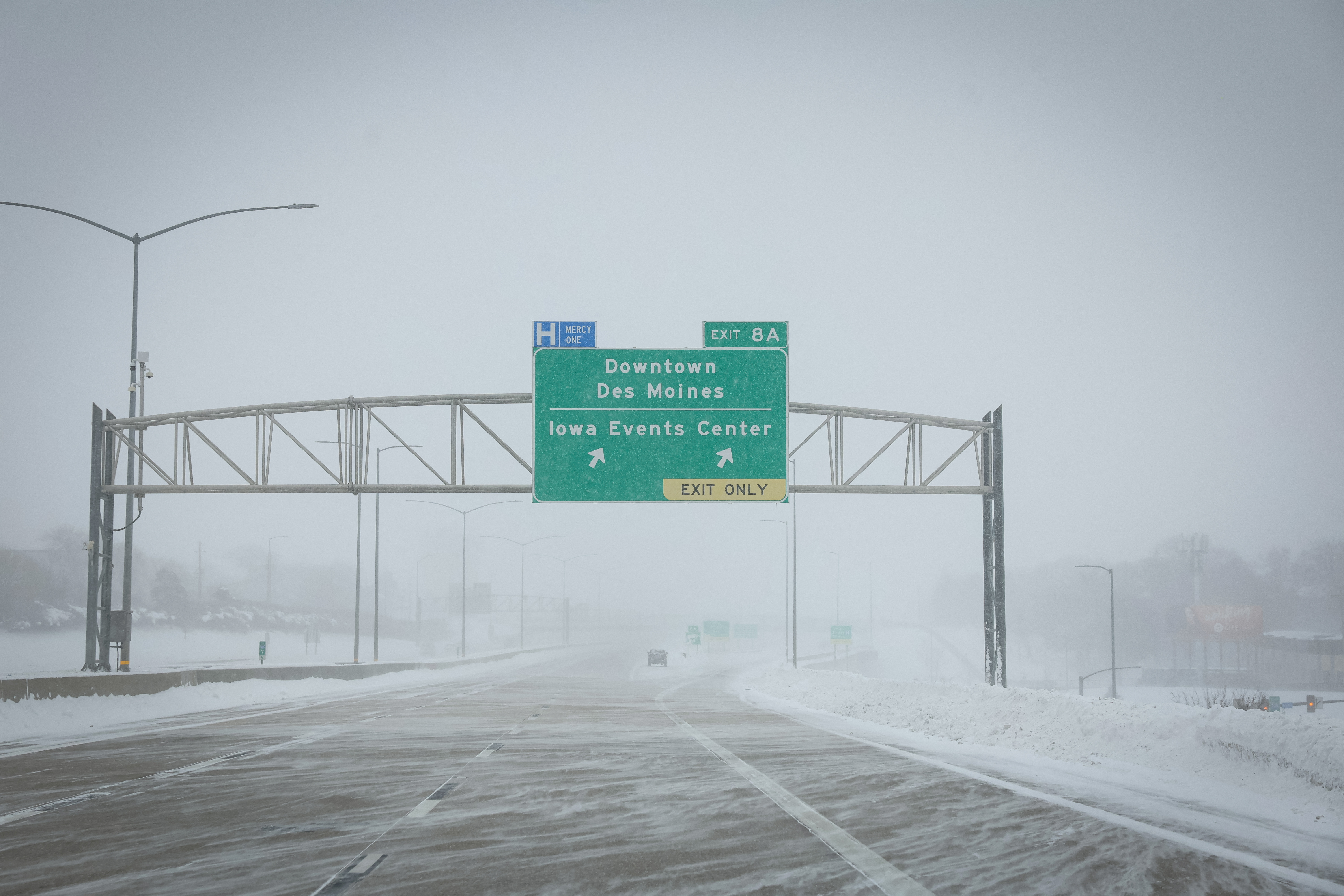 Blowing snow covers a highway after a blizzard left several inches of snow in Des Moines, Iowa, U.S., January 13, 2024. 