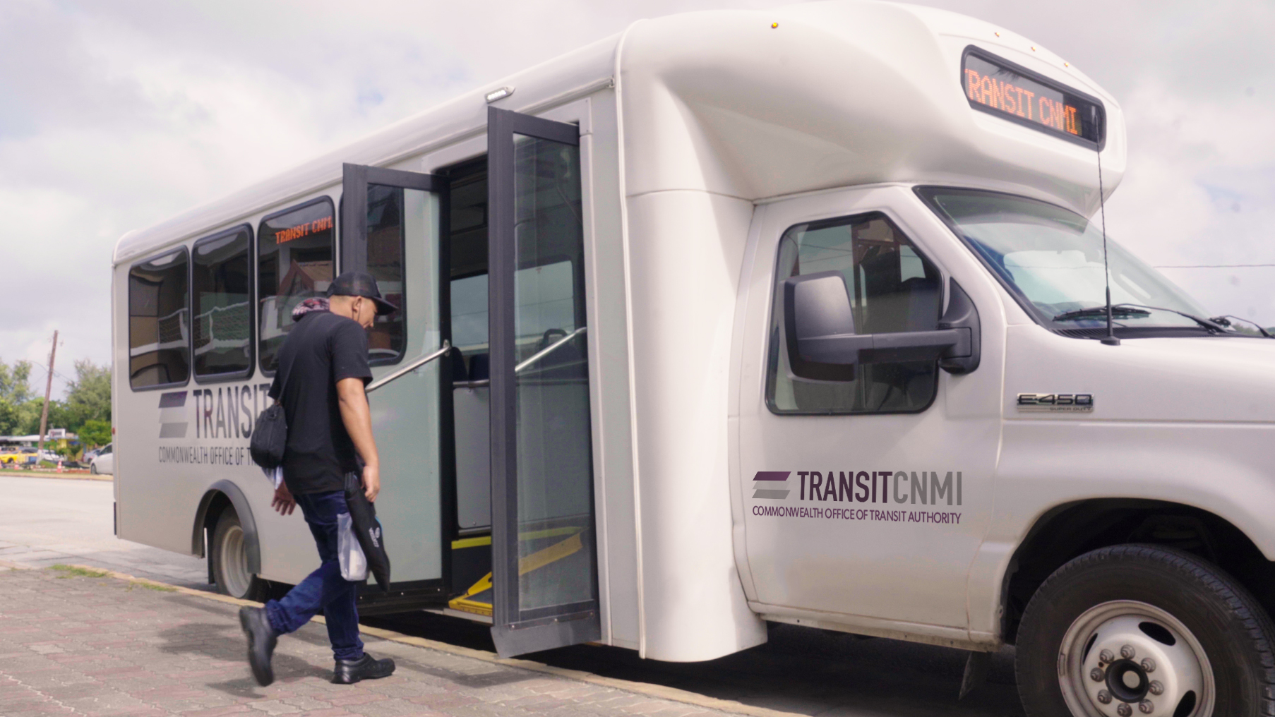 A rider boards Transit CNMI's Blue Line 1B.