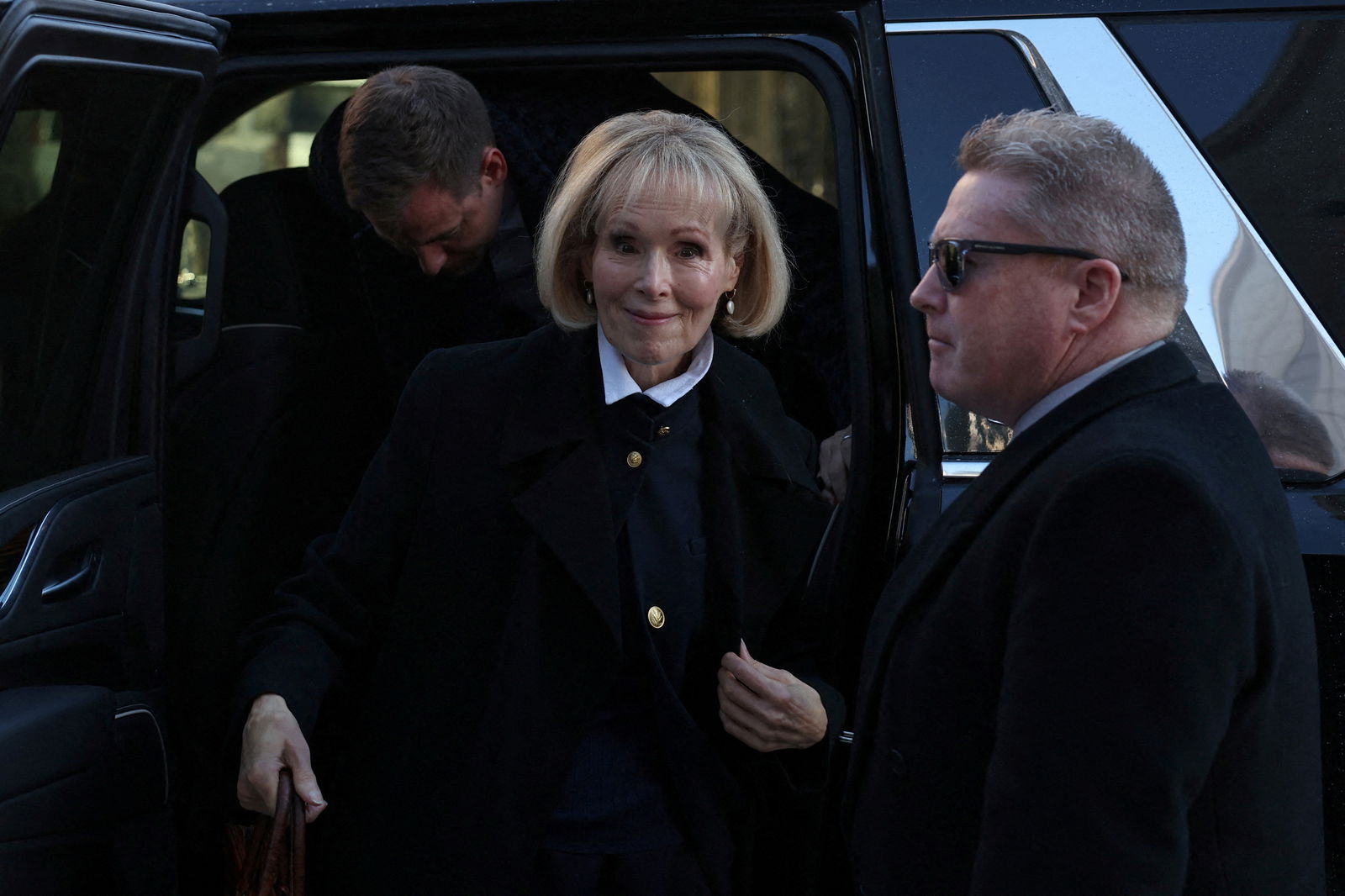 E. Jean Carroll steps out of the car as she arrives to Manhattan Federal Court, in the second civil trial after she accused former U.S. President Donald Trump of raping her decades ago, in New York City, U.S., January 22, 2024. 