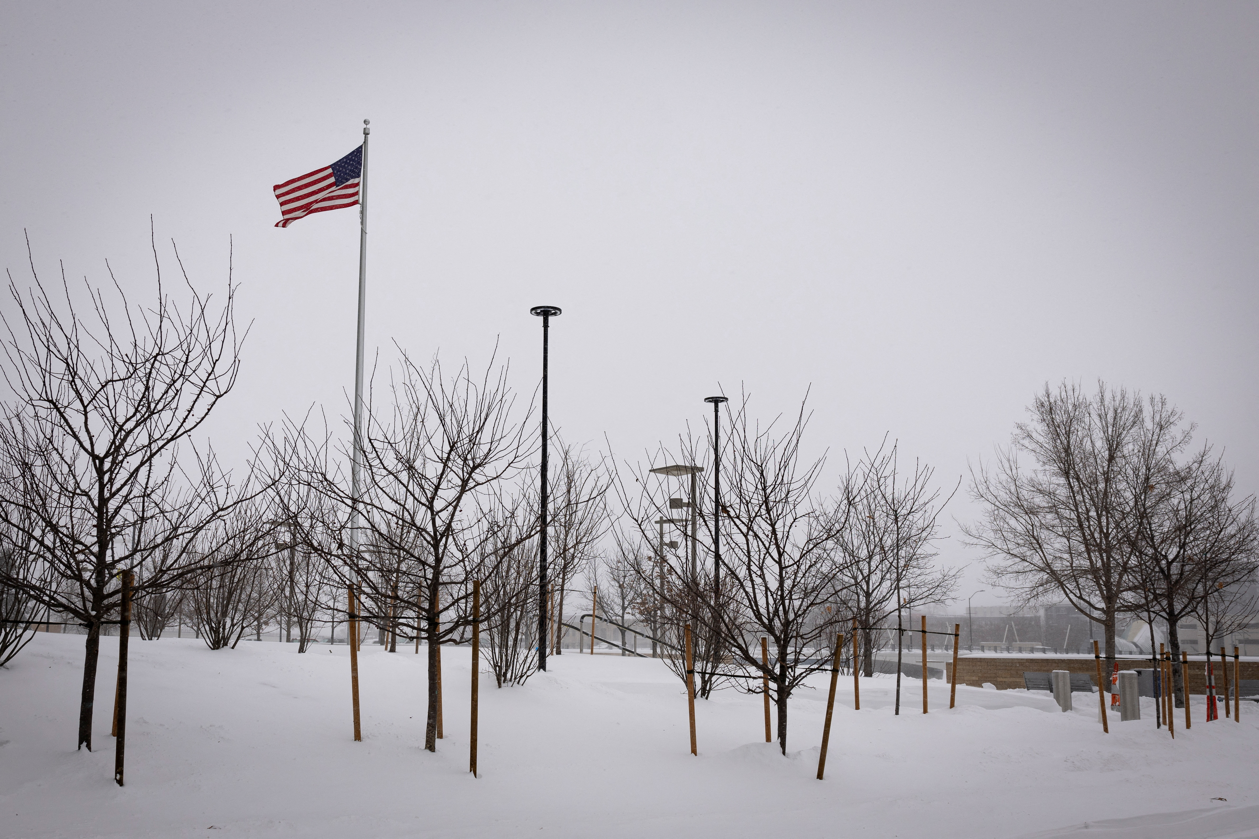 An American flag waves after a blizzard left several inches of snow, in Des Moines, Iowa, U.S., January 13, 2024. 