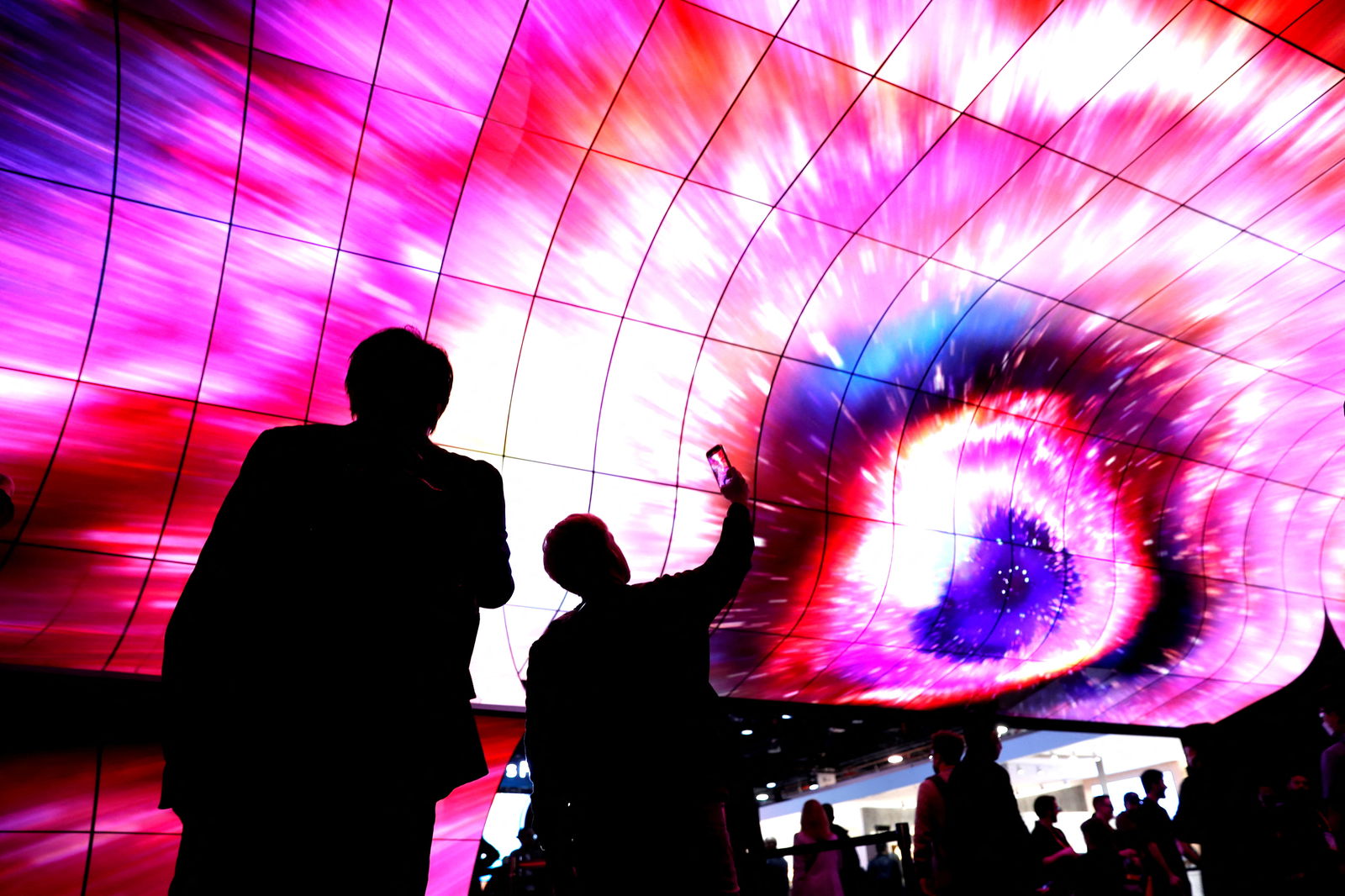 Attendees watch a display on curved OLED screens at the LG Electronics booth during CES 2023, an annual consumer electronics trade show, in Las Vegas, Nevada, U.S. January 6, 2023. 