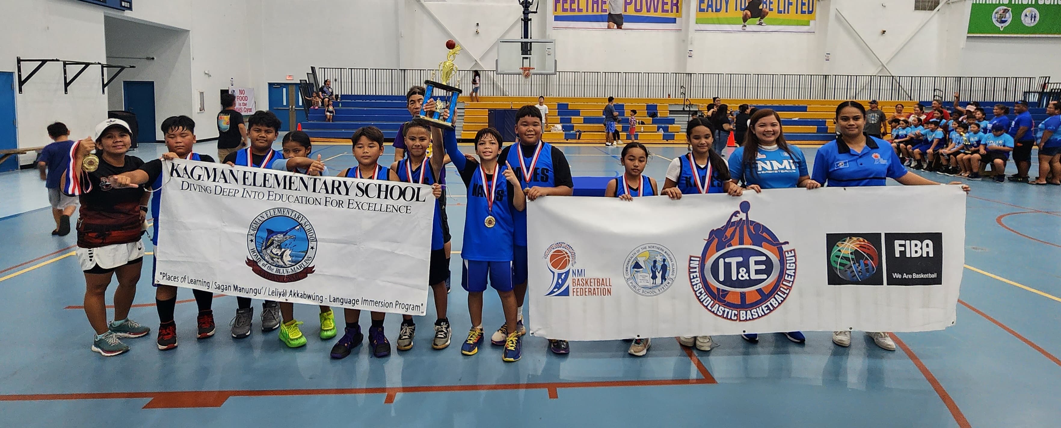 KAG 1 players pose with the co-ed elementary school division championship trophy of the IT&E Interscholastic Basketball League SY23-24 at the Marianas High School gym on Saturday.