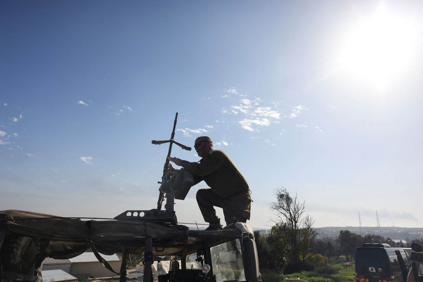 An Israeli soldier adjusts a weapon on top of a vehicle, amid the ongoing conflict between Israel and the Palestinian Islamist group Hamas, near Israel's border with Gaza, southern Israel January 21, 2024. 