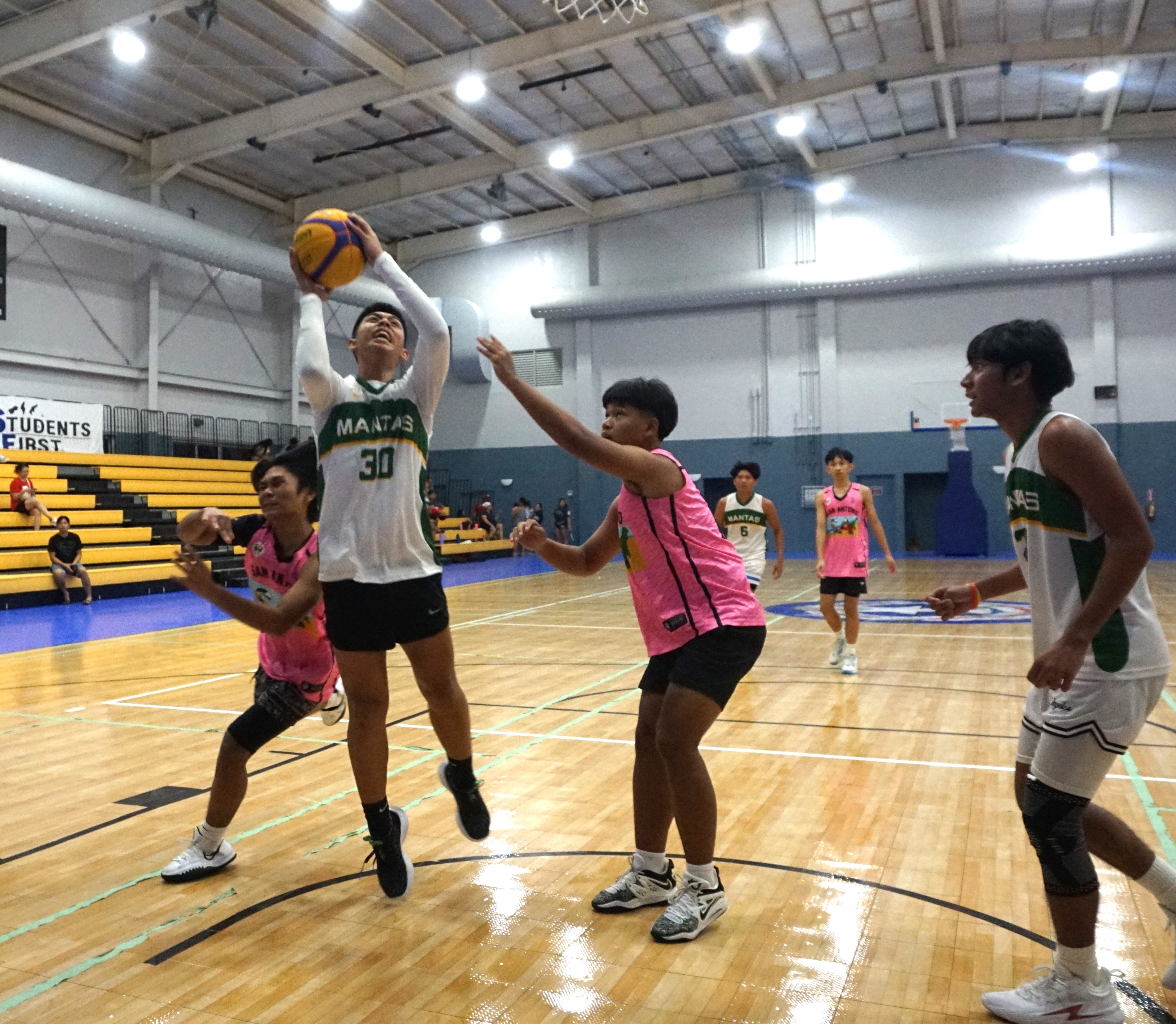 Madflex's Christian Lucero gets fouled as he goes up for the finish during the U16 division title game of the Matt D's 3x3 Youth Tournament at the Ada gym on Saturday