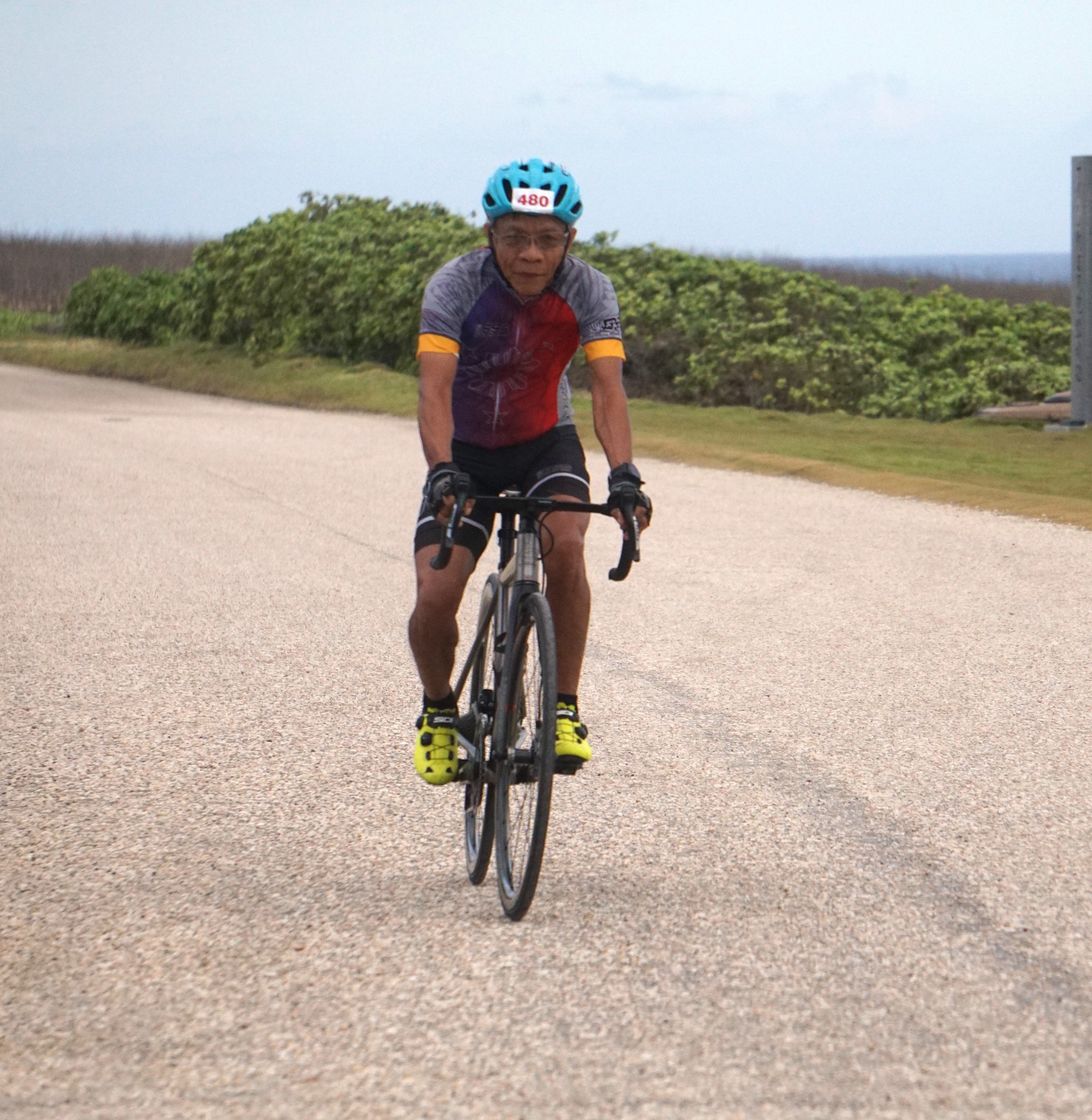 Ponce Corotan smiles as he nears the finish line of the 2024 Rotary Club of Saipan "End Polio Now" Cycling Challenge at Banzai Cliff on Saturday. 