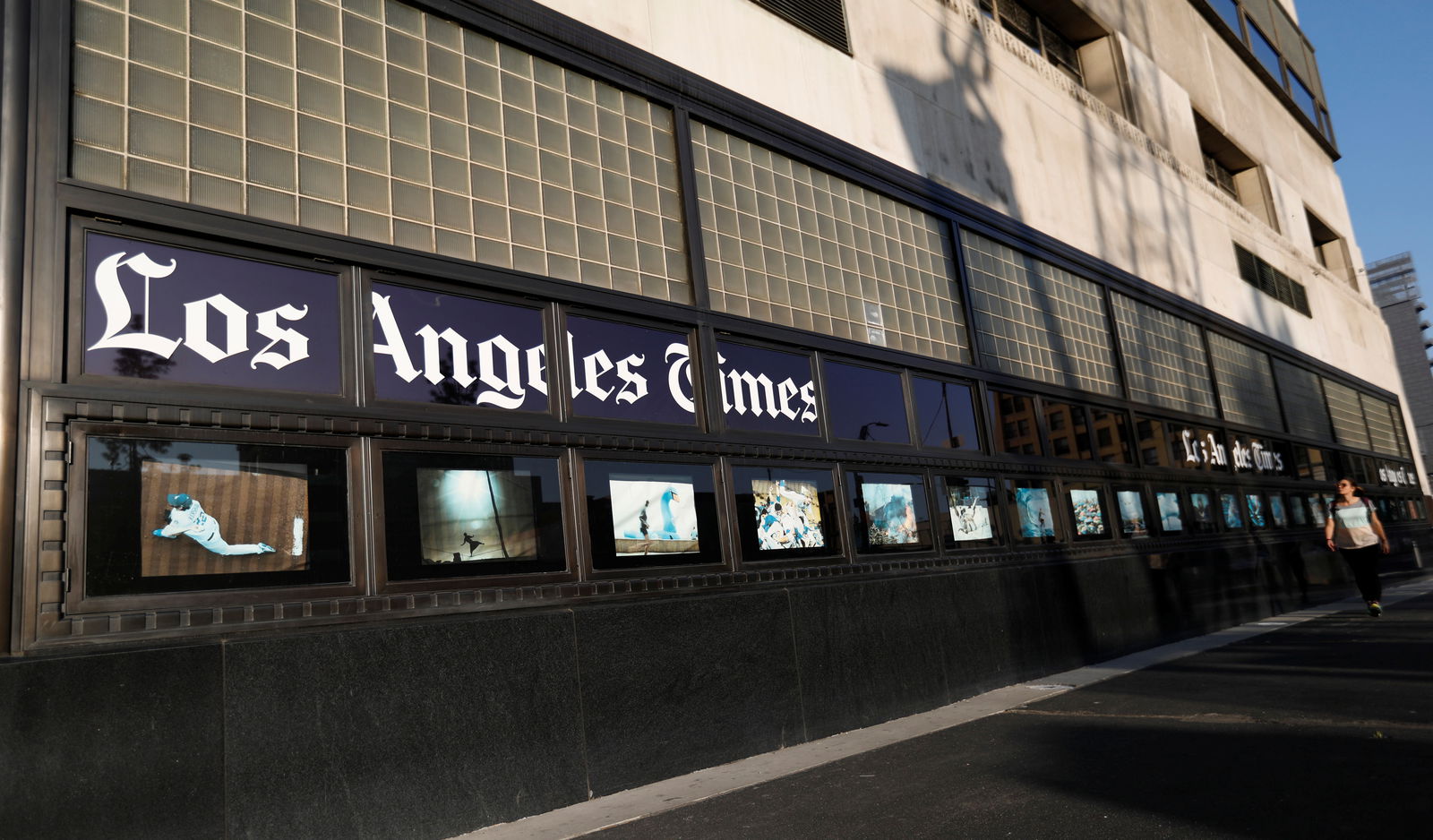People walk by the Los Angeles Times building in Los Angeles, California, U.S., February 6, 2018. 