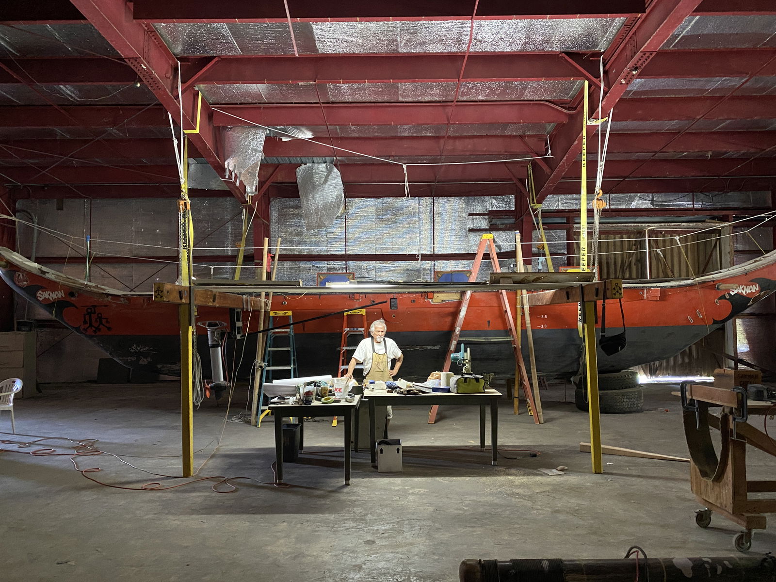Mario Borja poses in front of Che'lu, a 47-foot-long traditional Chamorro vessel made from California Redwood.