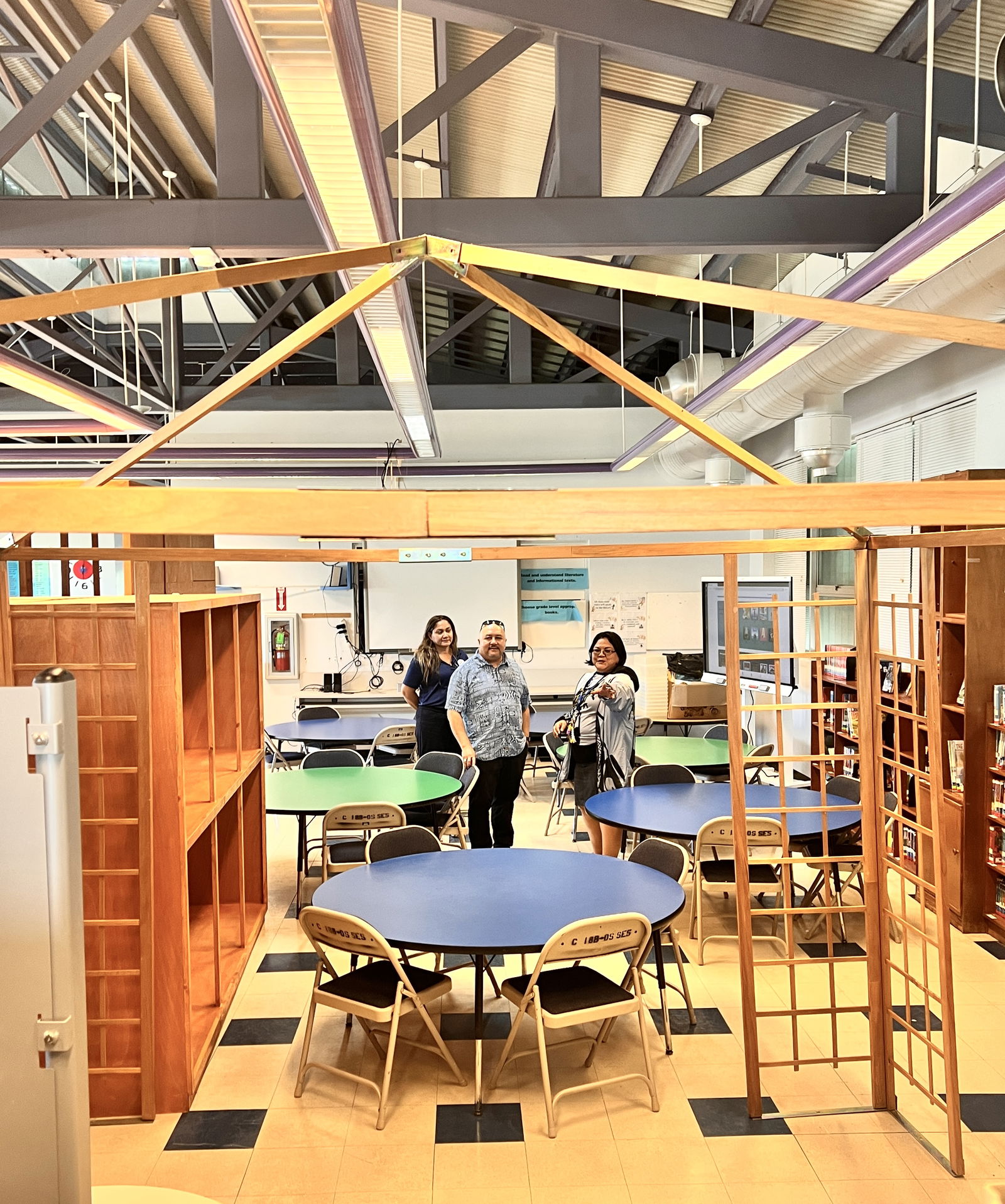 Commissioner of Education Dr. Lawrence F. Camacho and Special Education Program Director Donna M. Flores receive an update on the ongoing repair and construction work at the Sinapalo Elementary School library.