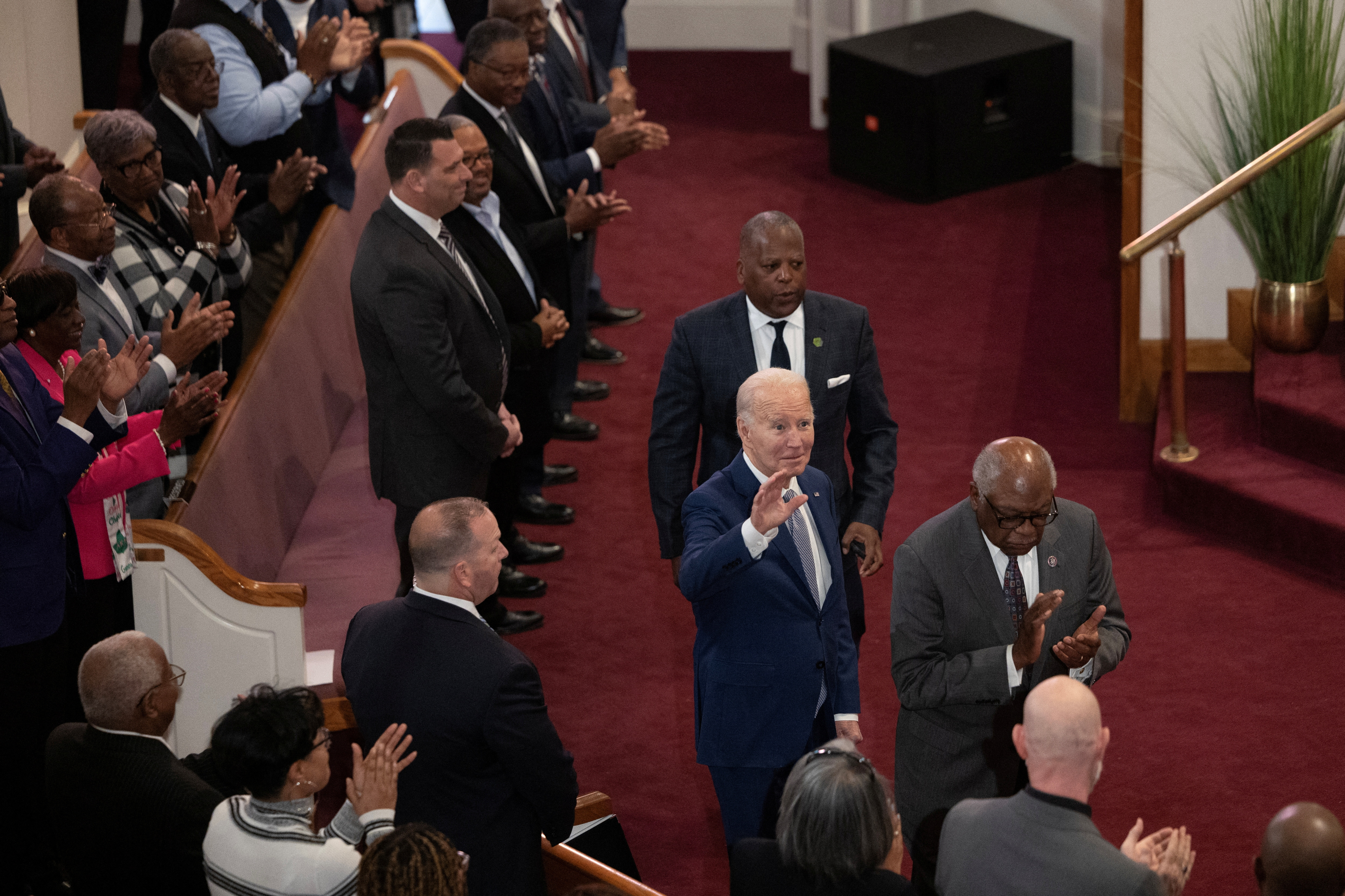 U.S. President Joe Biden walks in with Rep. Jim Clyburn (D-SC) while participating in a church service at Saint John Baptist Church in West Columbia, South Carolina, U.S., January 28, 2024. 