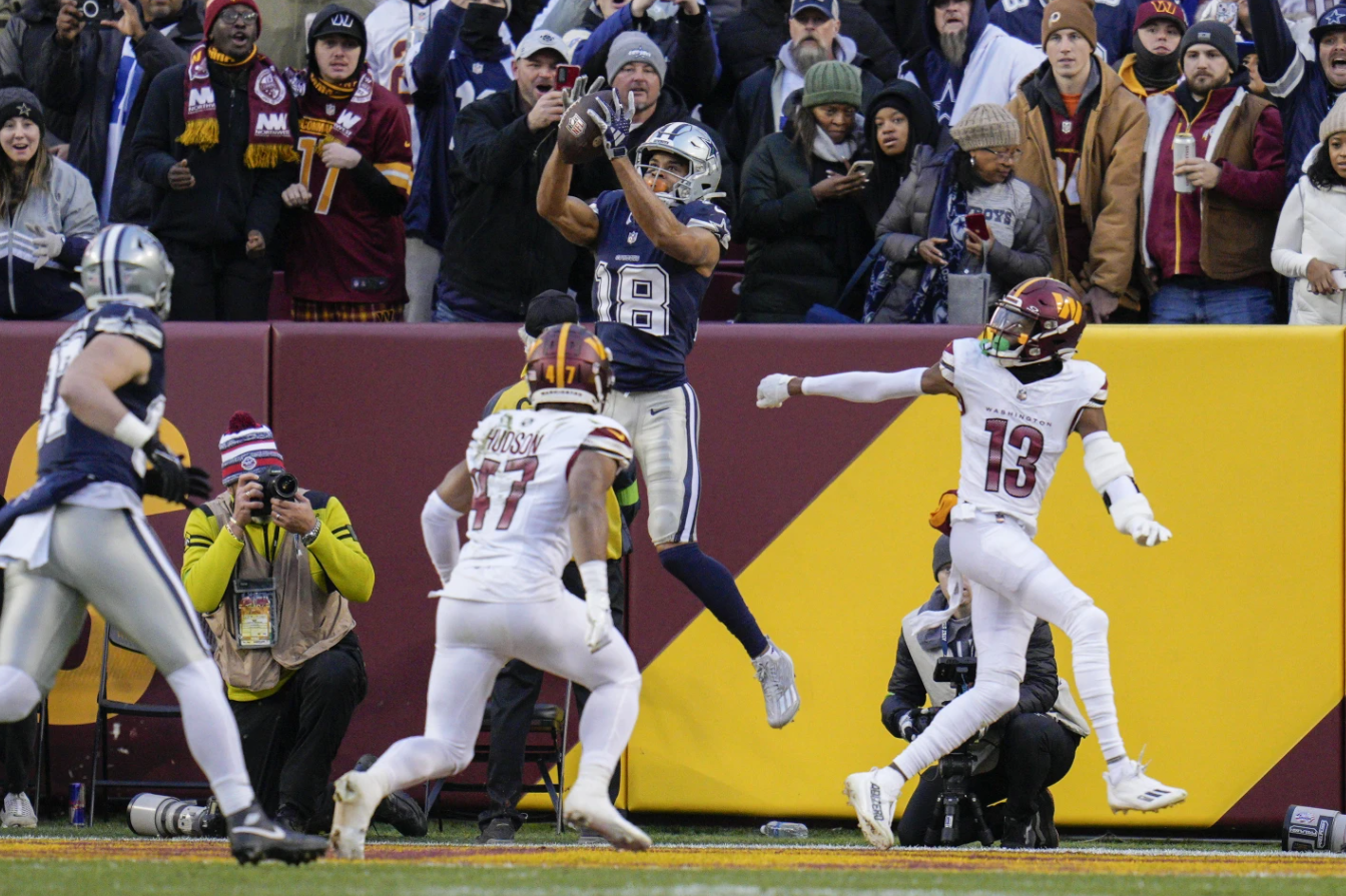 Dallas Cowboys wide receiver Jalen Tolbert (18) makes  a touchdown catch against Washington Commanders linebacker Khaleke Hudson (47) during the first half of an NFL game, Sunday, Jan. 7, 2024 in Landover, Md.