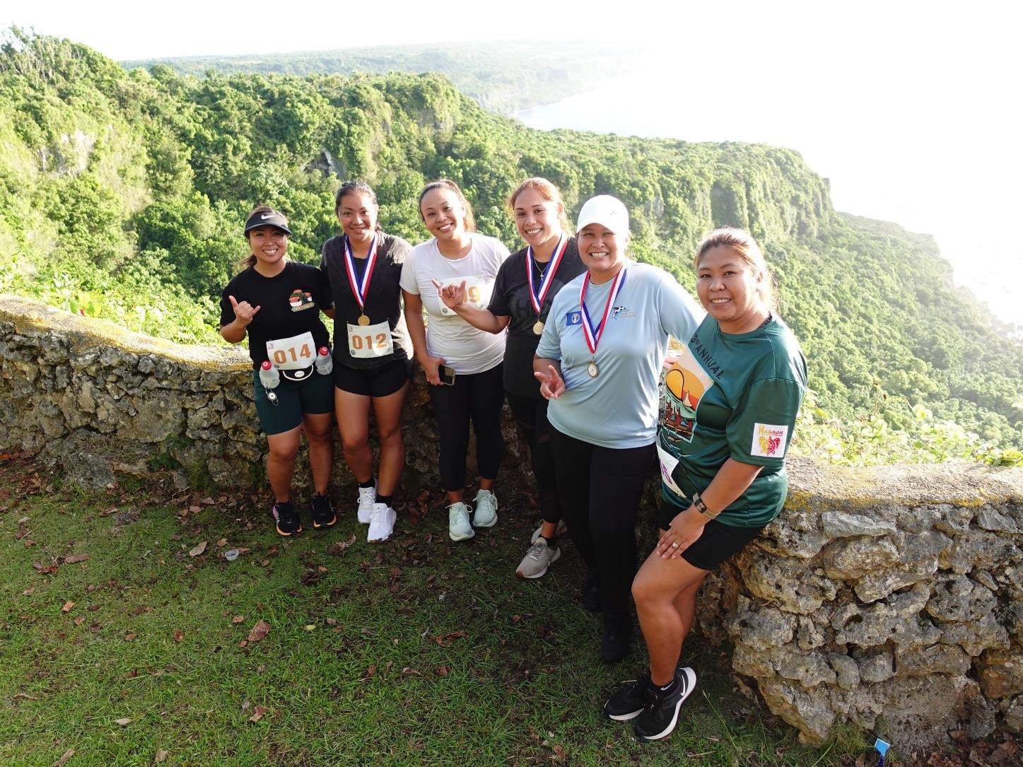 Catherine Attao, second right, and other runners from the Kanoa Football Club Women’s team under the Northern Mariana Islands Football Association commemorate their finish with a photo at Rota Marathon 2024 on Jan. 13, 2024.