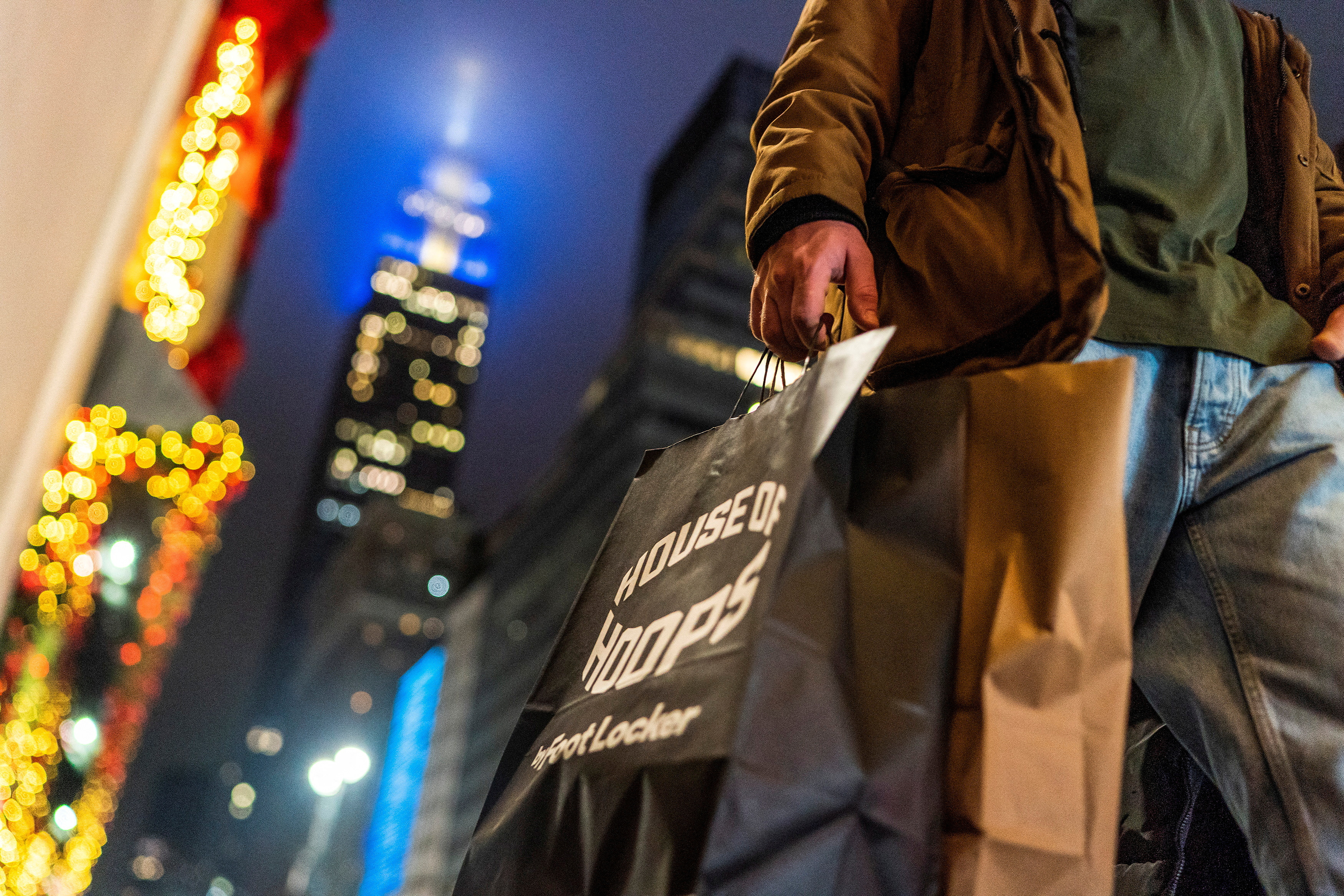 A man carries his shopping bags during the holiday season in New York City, Dec. 10, 2023.