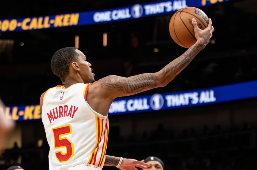 Atlanta Hawks guard Dejounte Murray (5) lays in the ball against Orlando Magic during fourth quarter at State Farm Arena in Atlanta, Georgia, Jan. 17, 2024.
