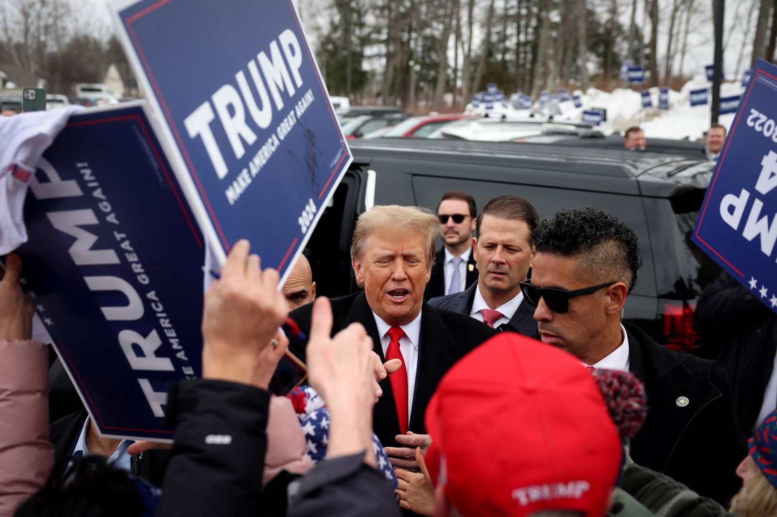 Former U.S. President and Republican presidential candidate Donald Trump greets supporters as makes a visit to a polling station on election day in the New Hampshire presidential primary in Londonderry, New Hampshire, U.S., January 23, 2024. 
