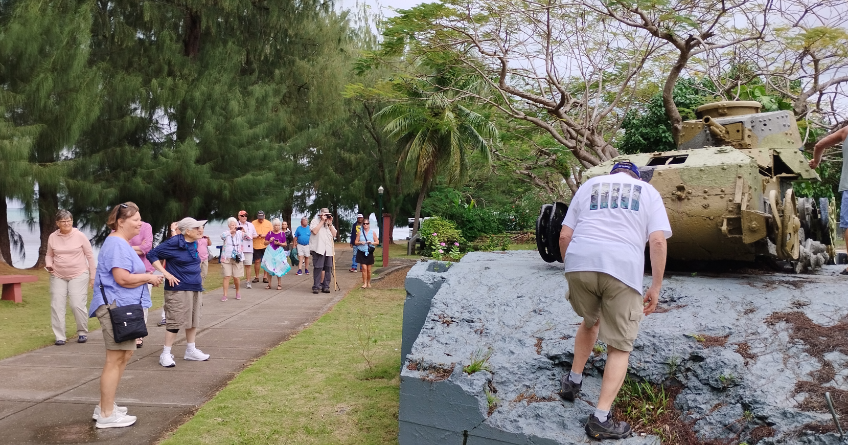 Guests reach out and touch one of Saipan's WWII relics.