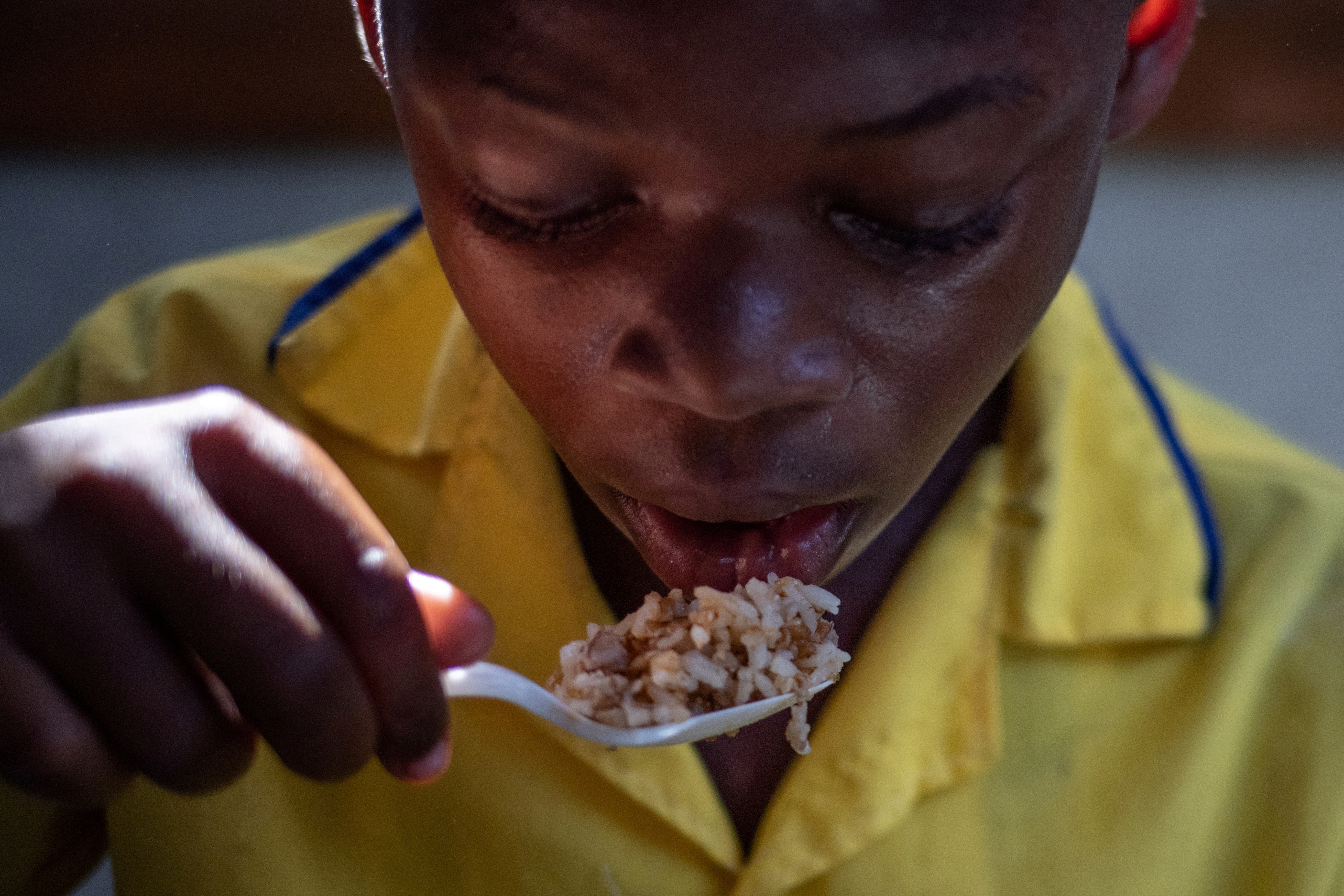 FILE PHOTO: Anderson, 9, eats a serving of beans and rice during a lunch break at the St Mary School of the Famille Kizito located in Cite Soleil, Port-au-Prince, Haiti November 5, 2021. 