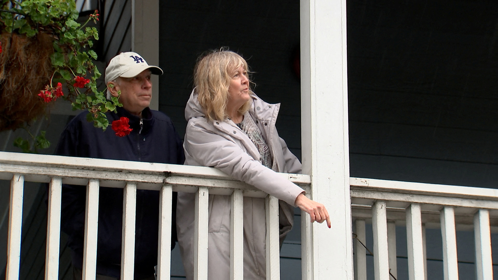 Alice White-Zmigrocki, 66, and her husband Joe Zmigrocki, 74, look from a Inn at Playa del Rey's balcony as workers (not pictured) pump flood water from the street surrounding the place, after heavy rains hit Southern California, in Los Angeles, California, U.S., February 5, 2024, as seen in this scree grab taken from a video. 