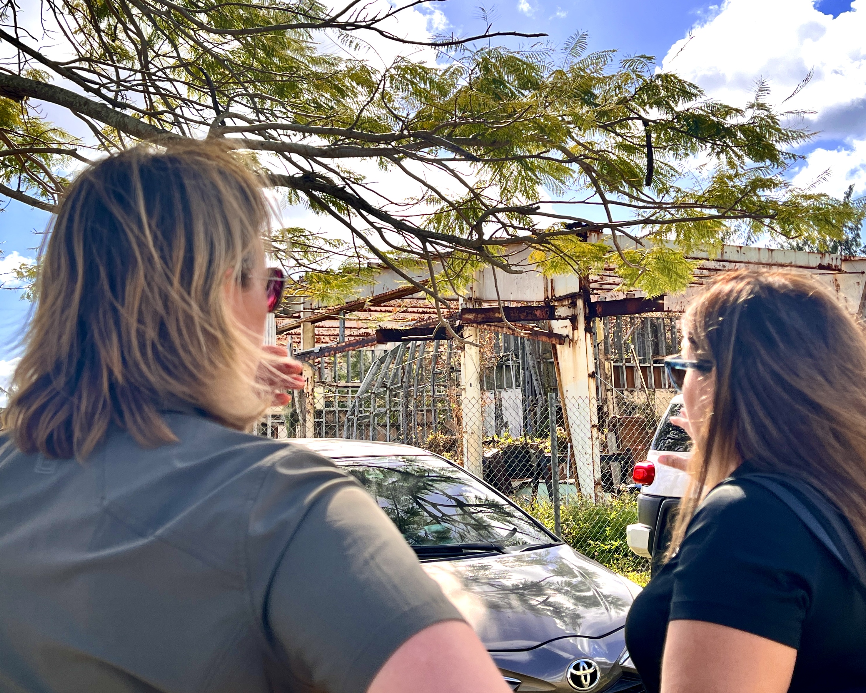 FEMA Administrator Deanne Criswell  and Acting Commissioner of Education Donna M. Flores look at one of the Hopwood school buildings damaged by Super Typhoon Yutu.