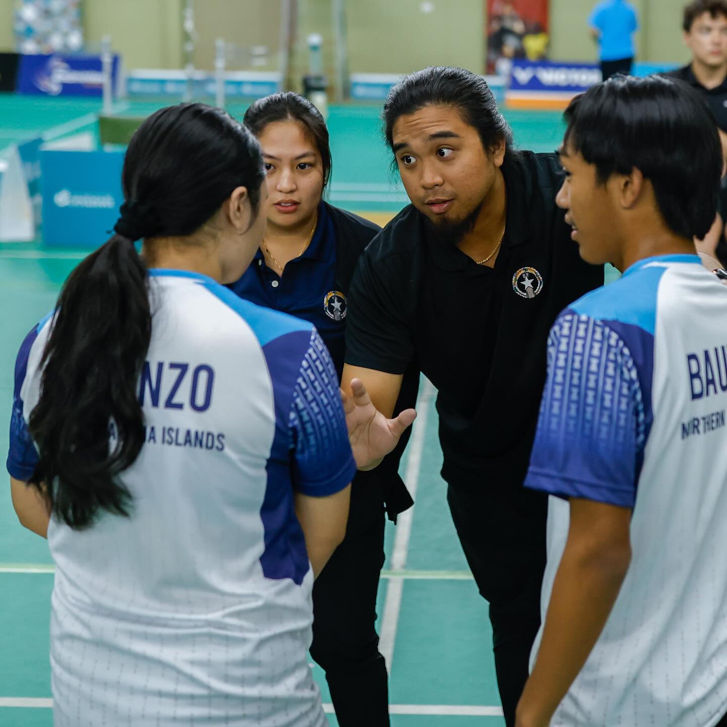 NMI coaches Ezekiel Macario and Janelle Pangilinan huddle with Shaina Malonzo and Marlon Bautista during a break from their mixed doubles game against Guam.