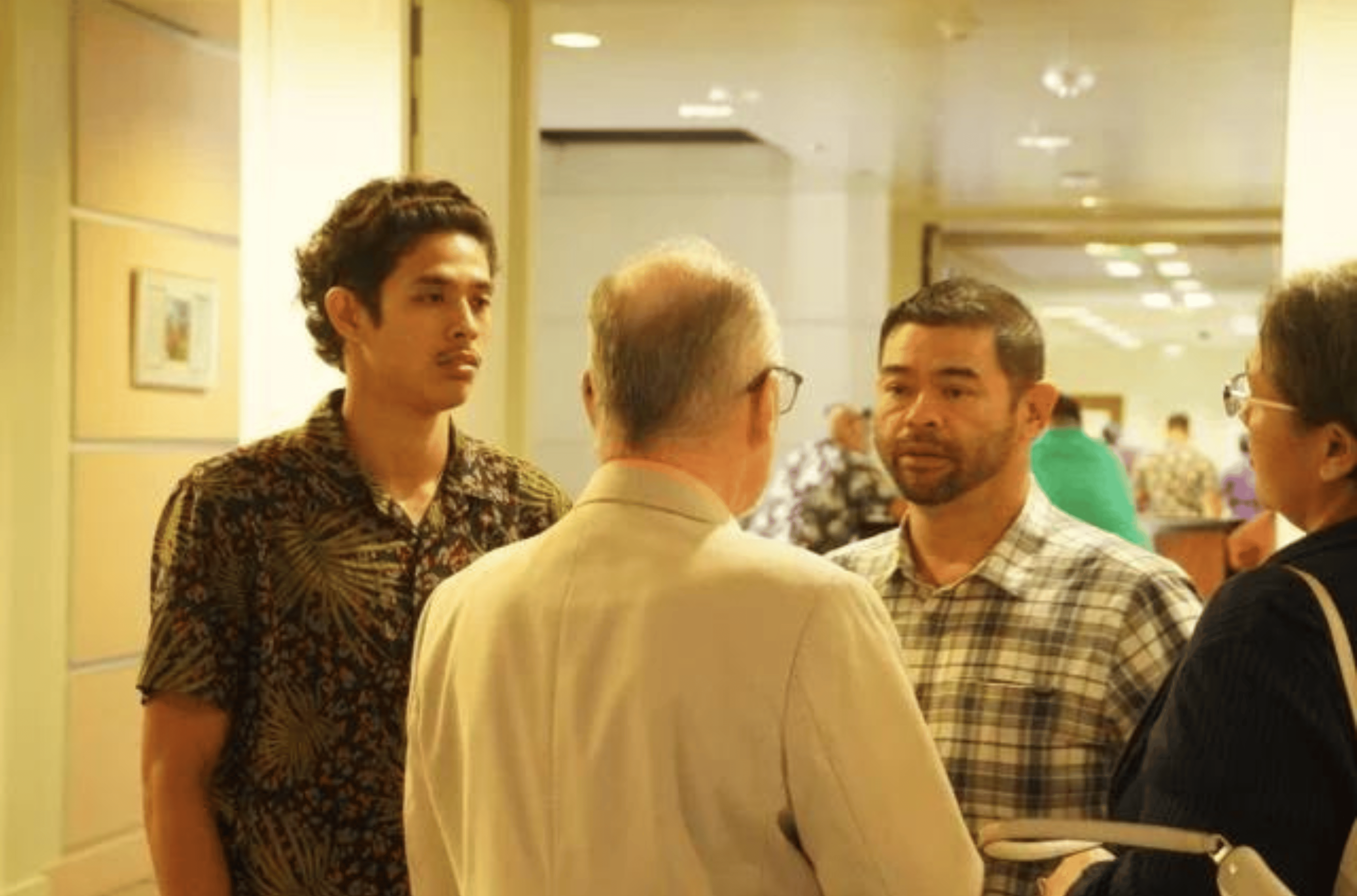 Jeffrey Garcia, right, in plaid shirt, and Jeremiah Garcia, left, speak to their lawyer on Friday, Feb. 23, 2024, in the Superior Court of Guam in Hagåtña after pleading no contest to misdemeanor assault. 