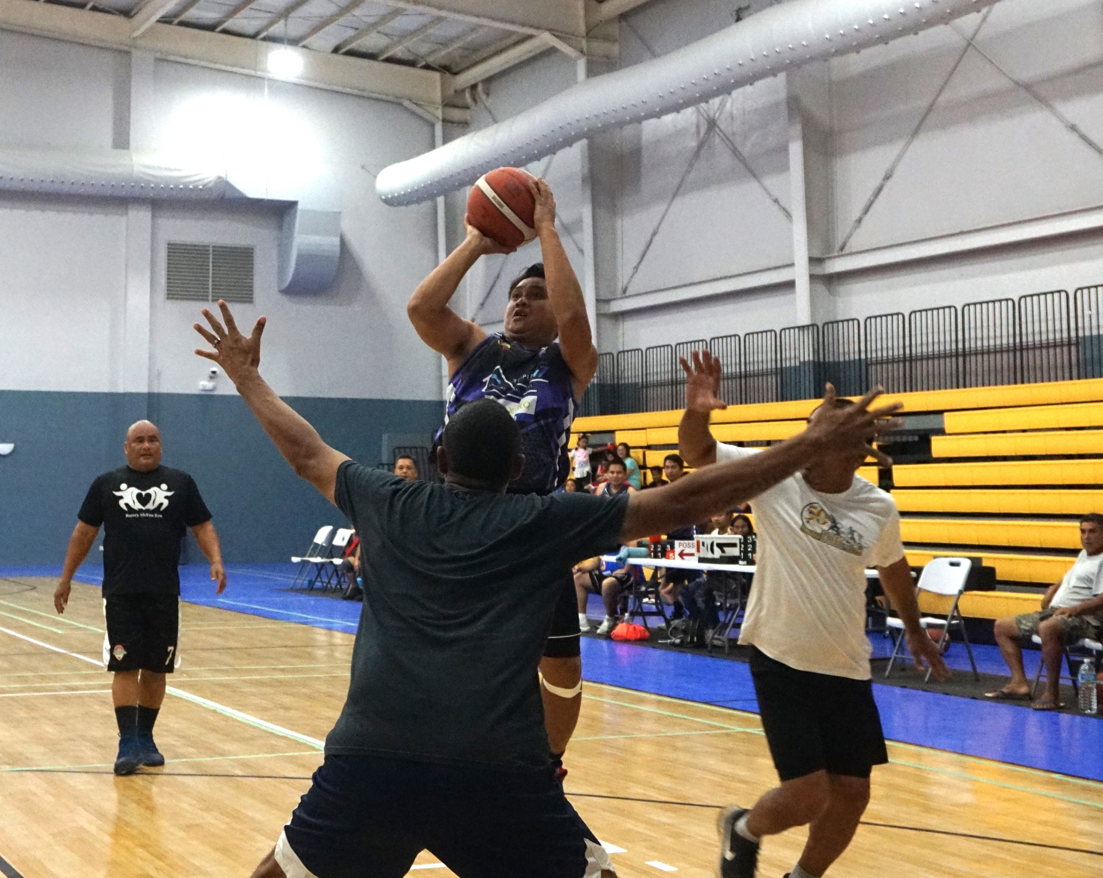 Triple L/Tax Pro's Rommel Usi pulls up for the mid-range jumper during a game against the Old Aces in the Masters “Internal” Basketball League at the Ada gym on Saturday.