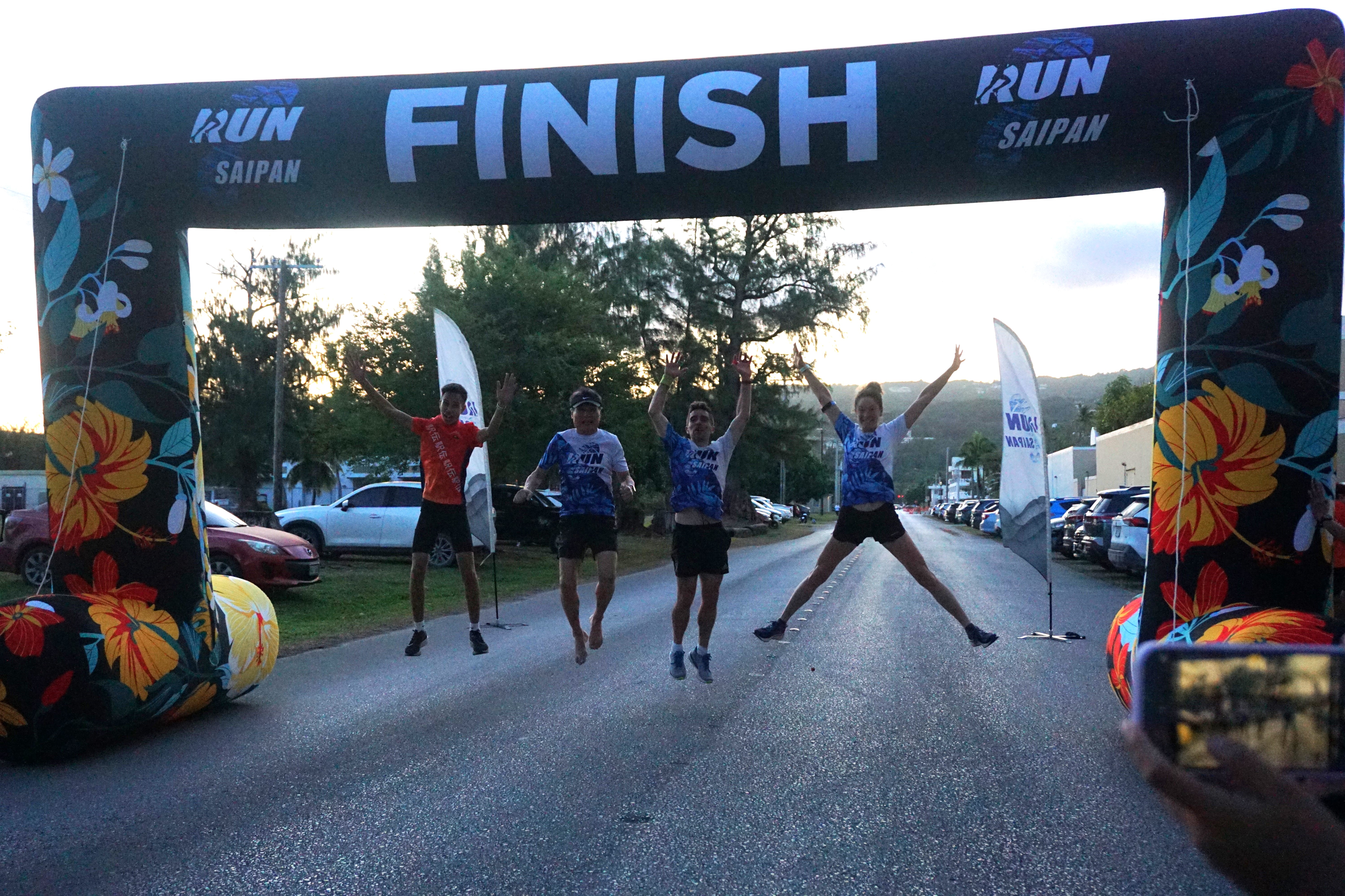 No Speed Limit team members jump for a photo after finishing second in Run Saipan’s 4th Marianas Ekiden at Micro Beach on Saturday.